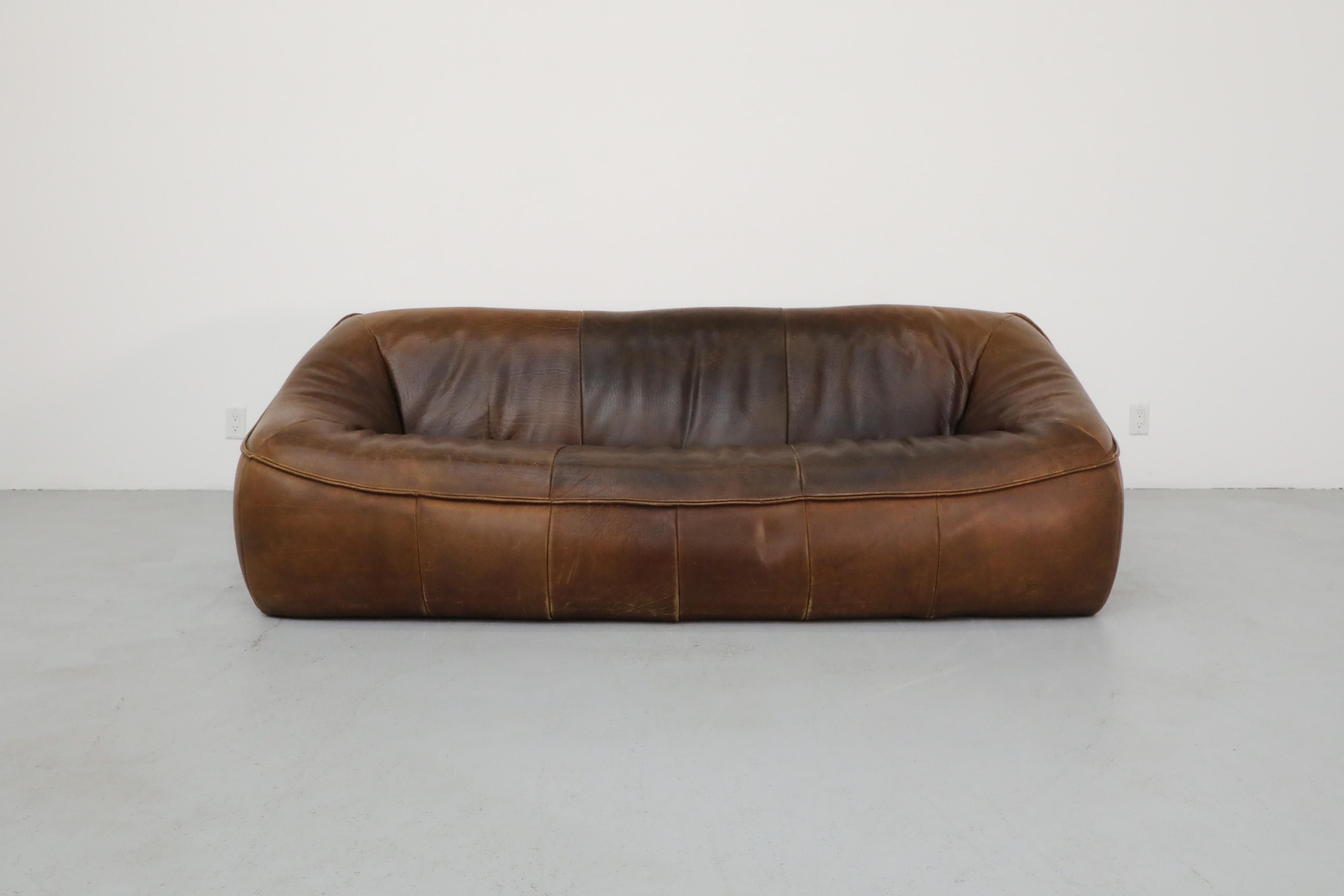 Mid-Century 'Ringo' three seater sofa designed by Gerard van den Berg for Montis. Soft form sofa with heavy dark brown leather. Manufactured by Montis and designed in 1979 by renowned co-founder Gerard van den Berg. This is elegant, contemporary,