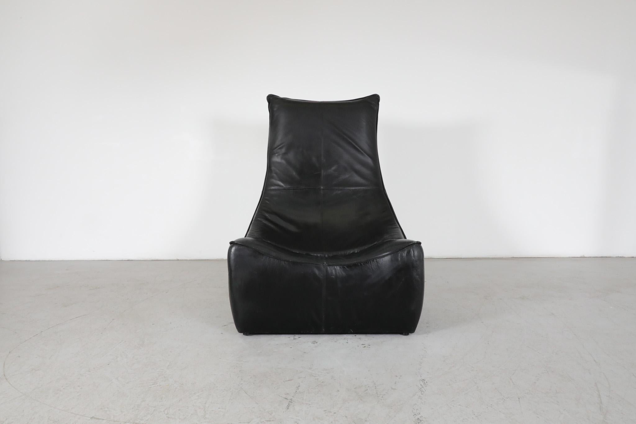 Mid-Century 'Rock' lounge chair in black leather designed by Gerard van den Berg for Montis. Iconic frameless design with soft curves and high back. Sleek single lounge chair version of 'The Rock' loveseat. In original condition with some light wear