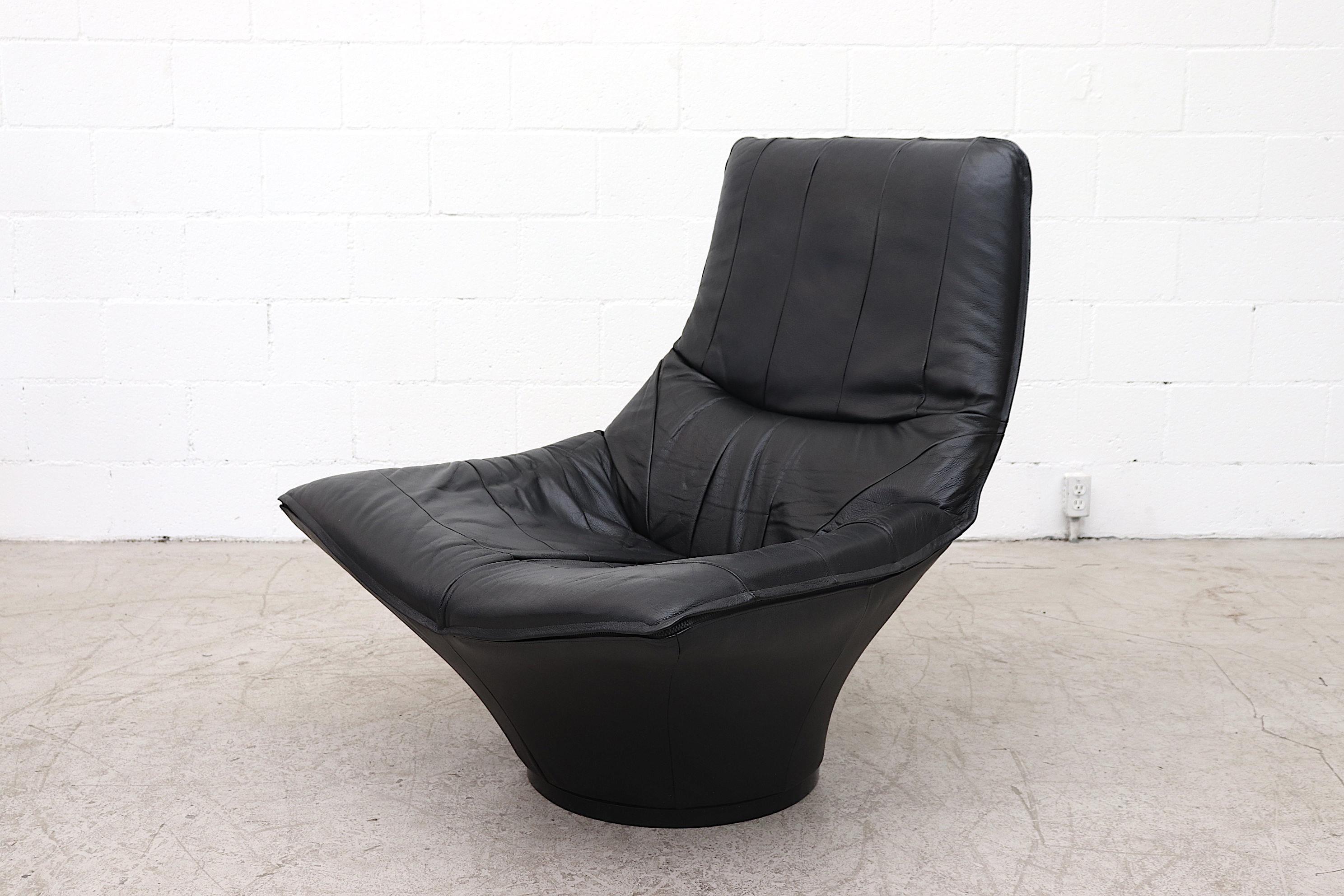 Impressive Gerard van den Berg style black leather lounge chair with cylinder base (non-swivel) and zipper detail. In original condition with some wear appropriate for age and use.