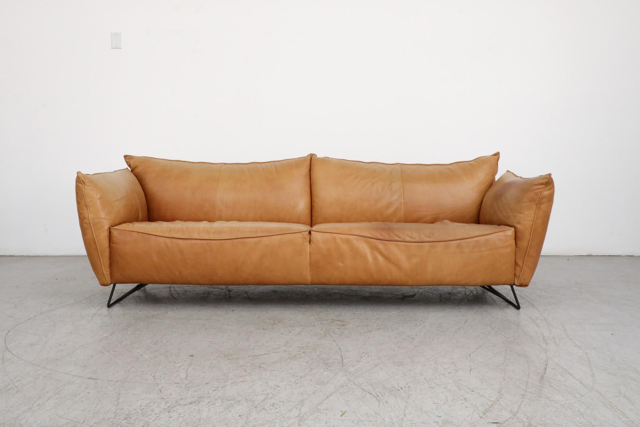 Beautiful Gerard Van Den Berg style butterscotch 3 seater sofa for Jess. Comfy and stylish leather sofa with attractive curves and mid-century flair. In impressive original condition with black enameled metal feet and some visible age appropriate