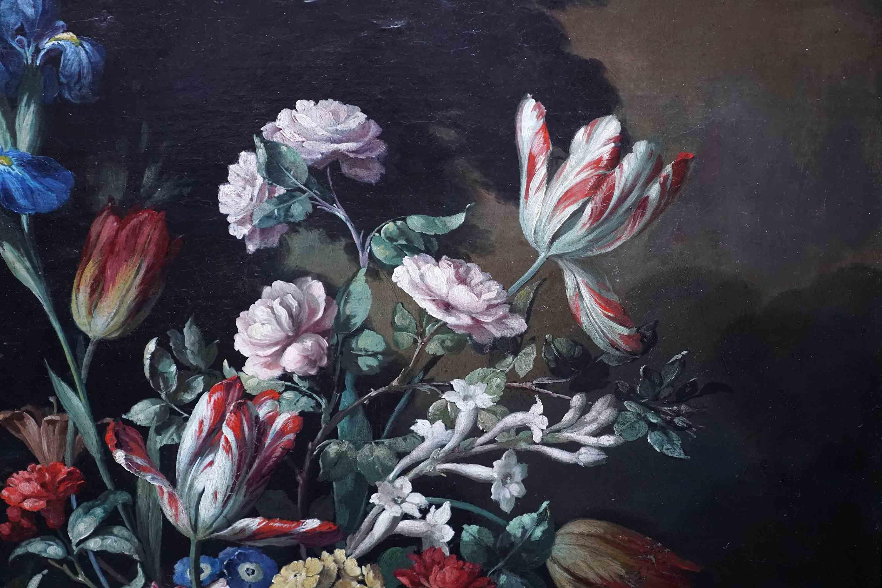 This superb vibrant Dutch 18th century Old Master floral oil painting is attributed to circle of Gerard Van Spaendonck. Painted circa 1790, it is a beautiful mixed floral still life flower arrangement in an ornate urn on a marble ledge against a