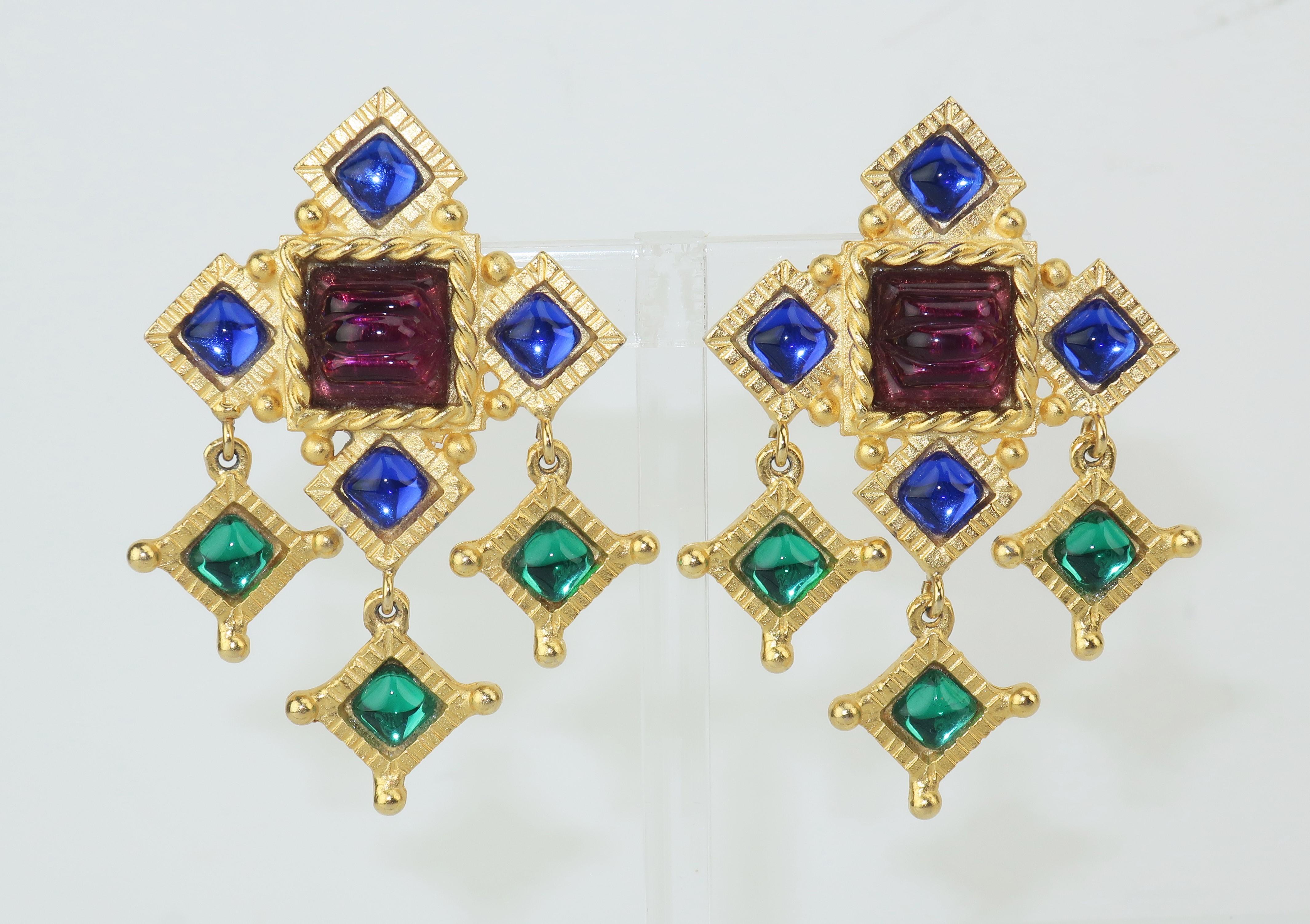 Byzantine style clip on earrings designed by Gerard Yosca in a matte gold with braided and incised details accented by amethyst purple, sapphire blue and emerald green cabochon glass.  Gorgeous!  Signed at the back and in excellent vintage