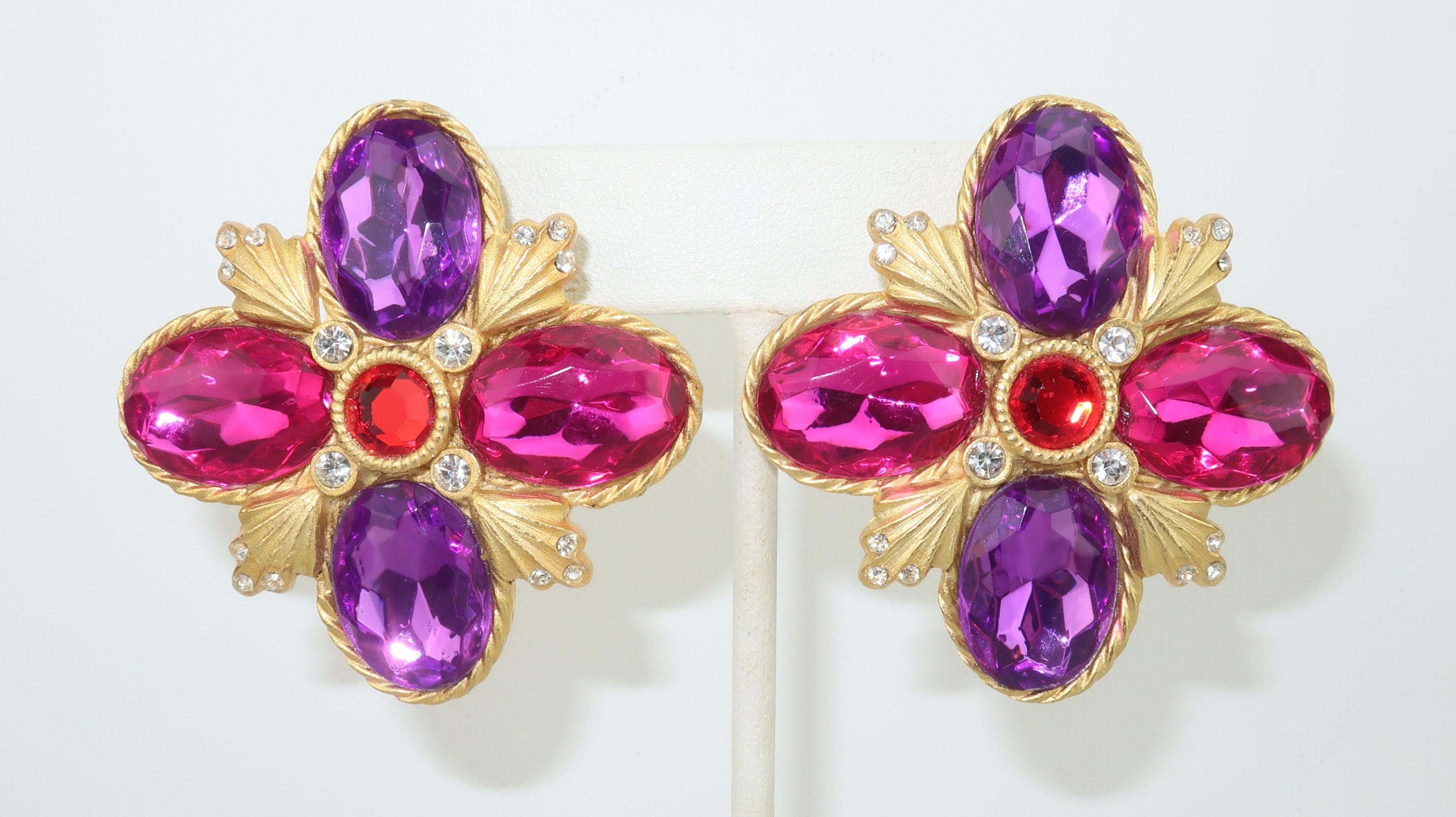 Large statement making clip on earrings by Gerard Yosca with a color rich 1980's opulence.  The earrings have a Maltese cross style silhouette in a brushed gold tone setting embellished with crystal rhinestones and faceted resin stones in shades of