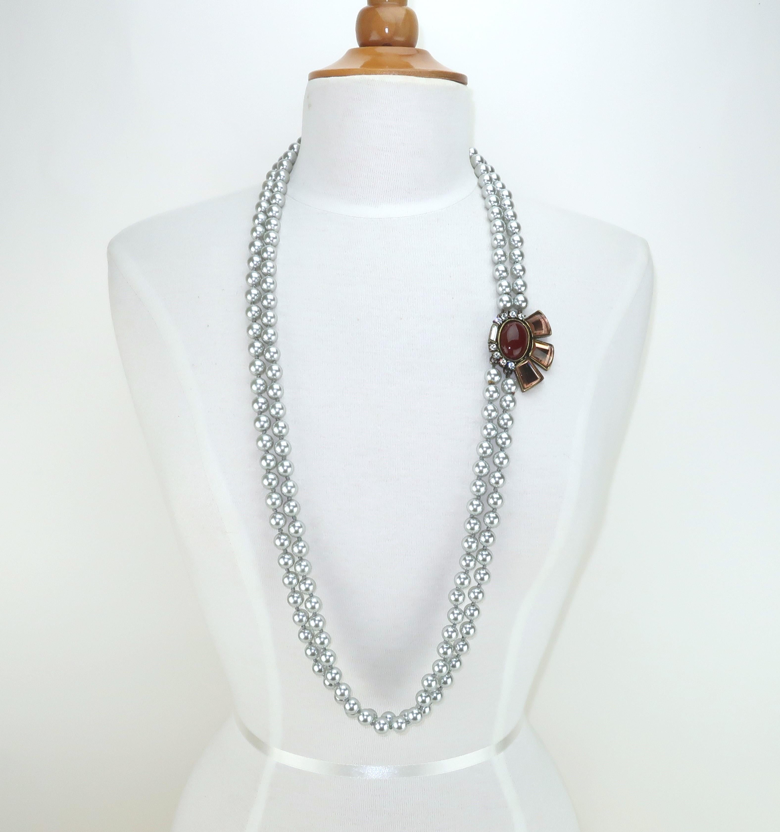 Class and elegance are expertly combined in this opera length faux pearl double strand necklace by Gerard Yosca. Mr. Yosca is know for his artisan jewelry and continues to design beautiful pieces today. This necklace measures 40” long and is