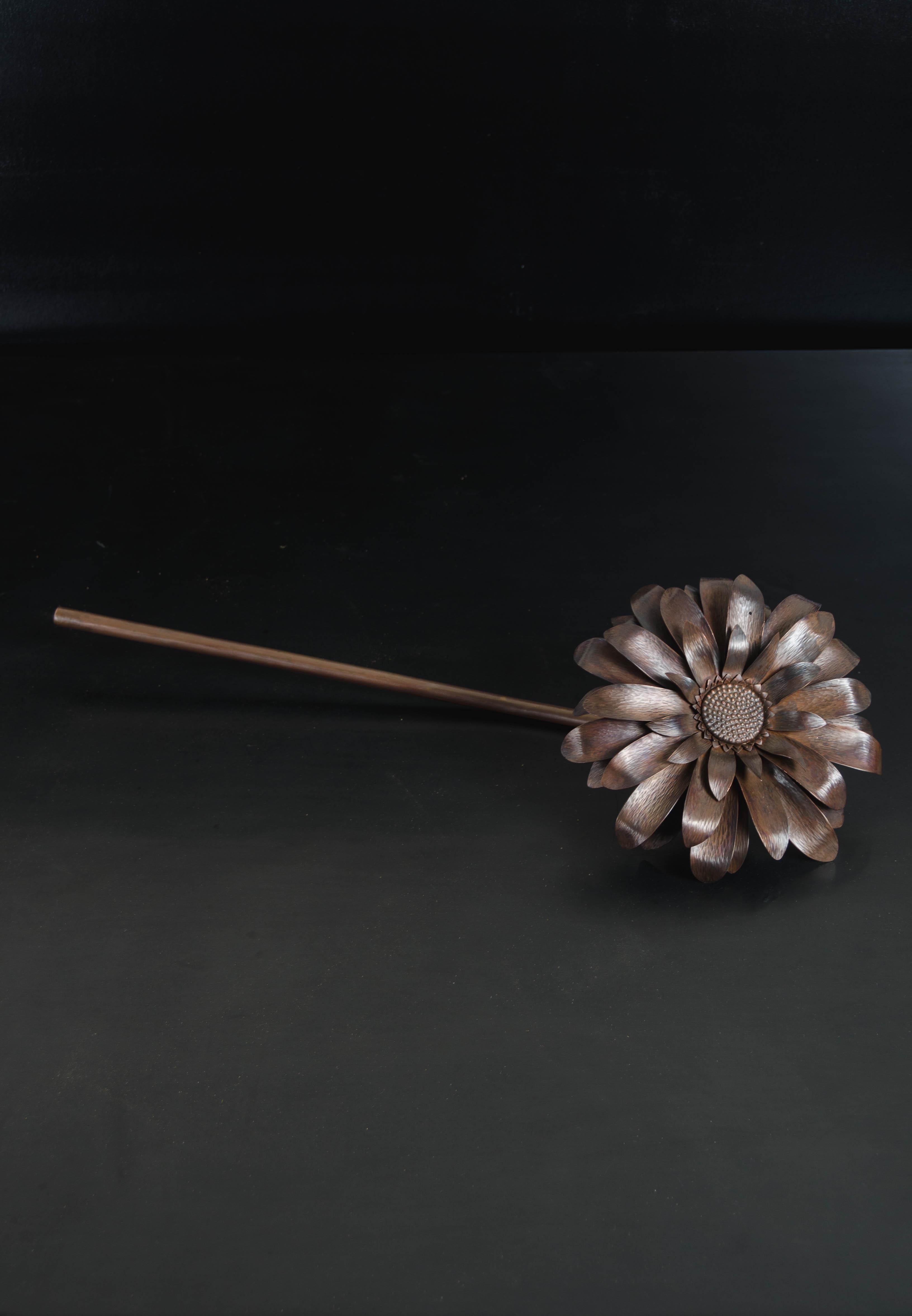 Gerber daisy flower
Antique copper
Hand repoussé
Limited edition 
Each piece is individually crafted and is unique.

Repoussé is the traditional art of hand-hammering decorative relief onto sheet metal. The technique involves using a hammer