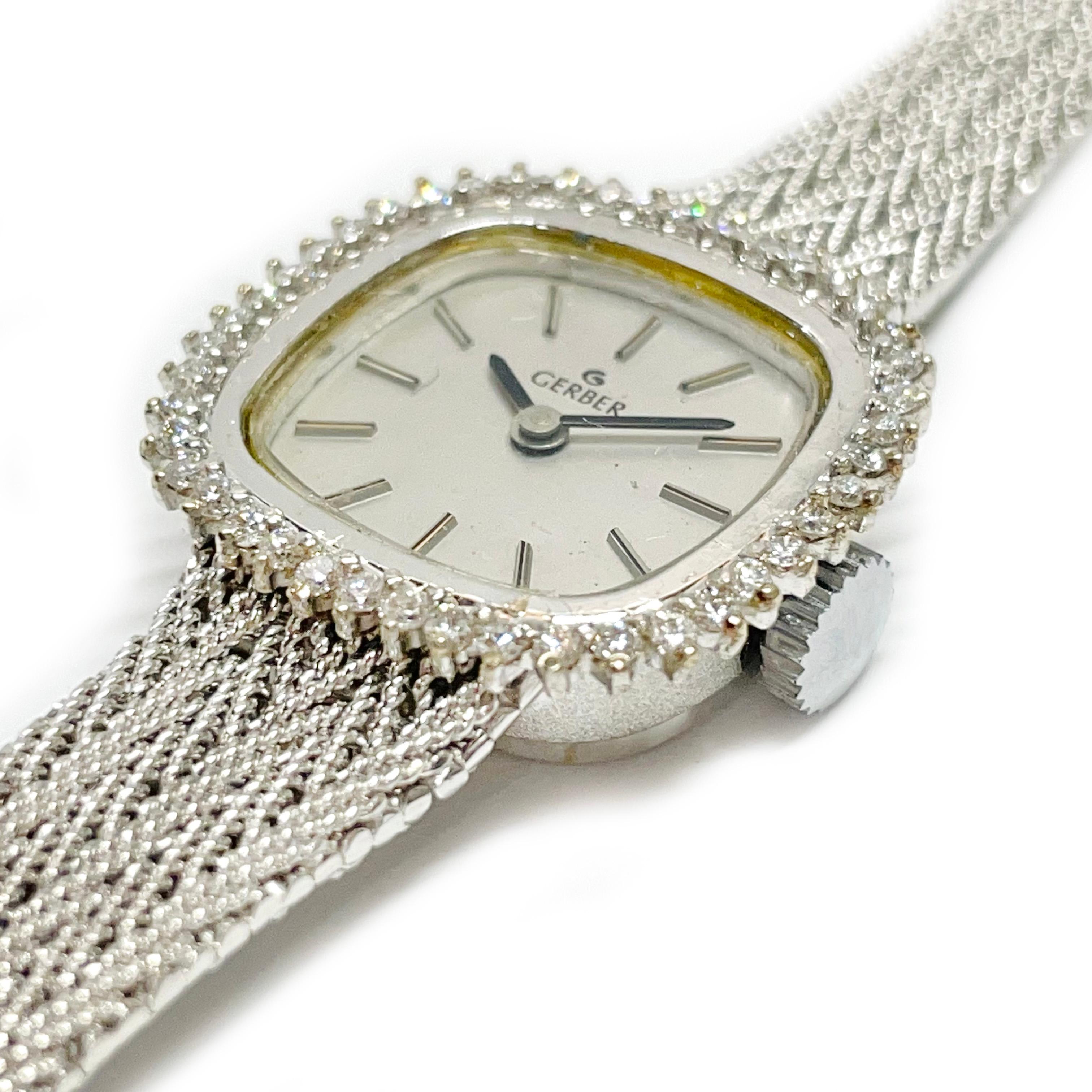 Vintage Gerber 14 karat white gold diamond Swiss movement wristwatch. The watch features a silver dial, black hour and minute hands, and a diamond surround. Approximately forty-four round prong-set diamonds adorn the surround. The diamonds have a
