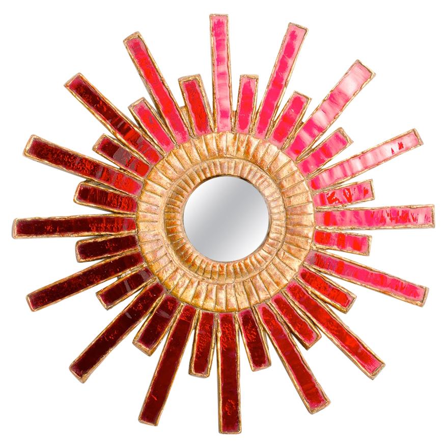 A circular red glass Mirror, in the Manner of Line Vautrin