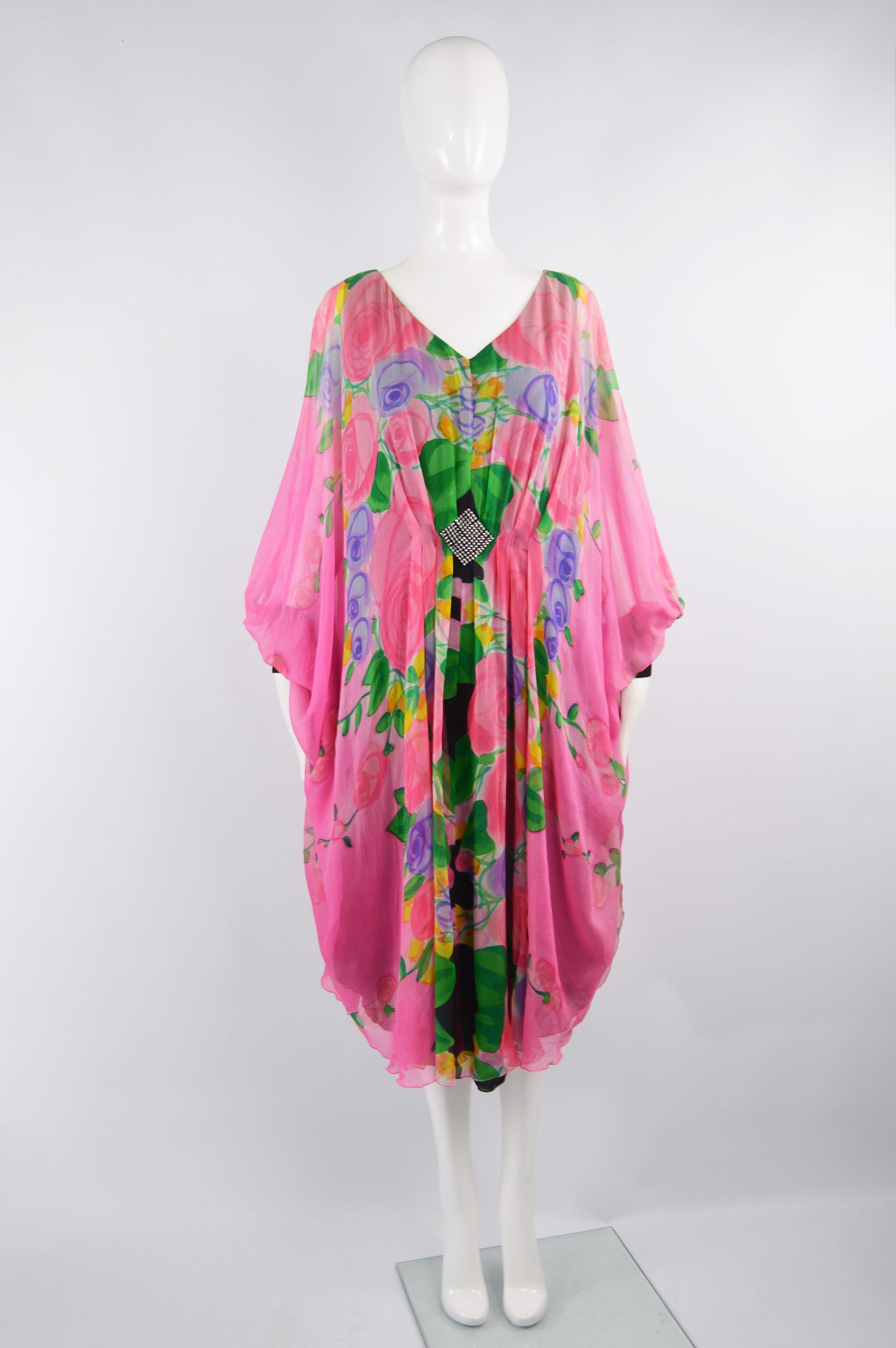 An incredible vintage womens kaftan dress from the 80s by eccentric luxury German fashion designer, Gerda Gregor. In a beautifully lightweight and floaty floral printed silk that is perfect for day or evening. 

Size: best fits a modern women's