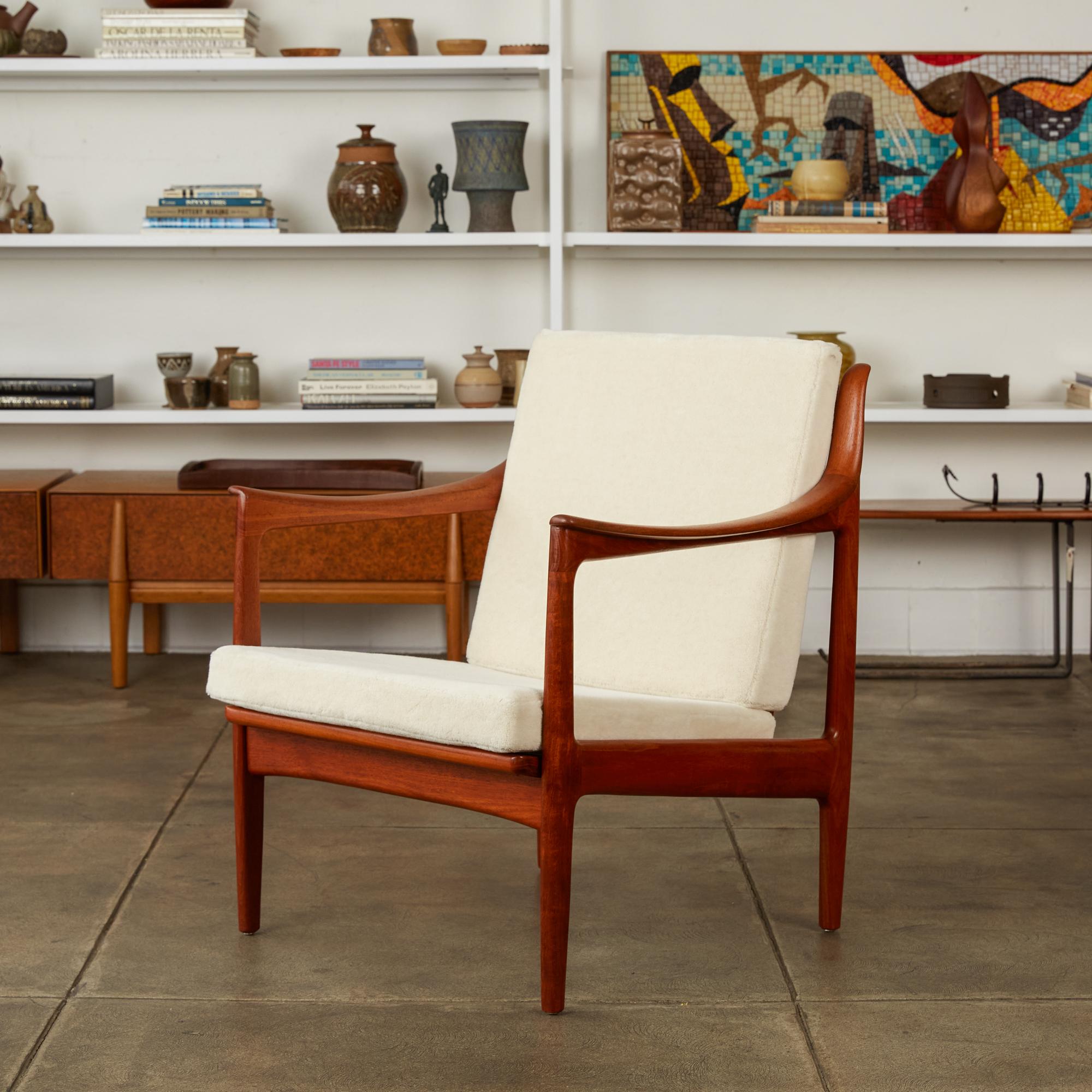 Lounge chair by Gerhard Berg for Westnofa, Norway, circa 1960s. The chair features a solid oiled teak frame with vertical slatted back and horned tips on the top of the back support. The seat and back cushions have been replaced and are covered in a