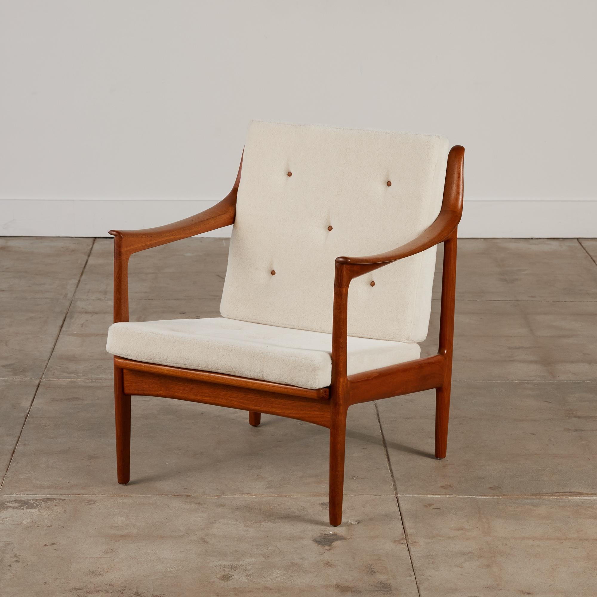 Lounge chair by Gerhard Berg for Westnofa, Norway, circa 1960s. The chair features a solid oiled teak frame with vertical slatted back and horned tips on the top of the back support. The seat and back cushions have been replaced and are covered in a