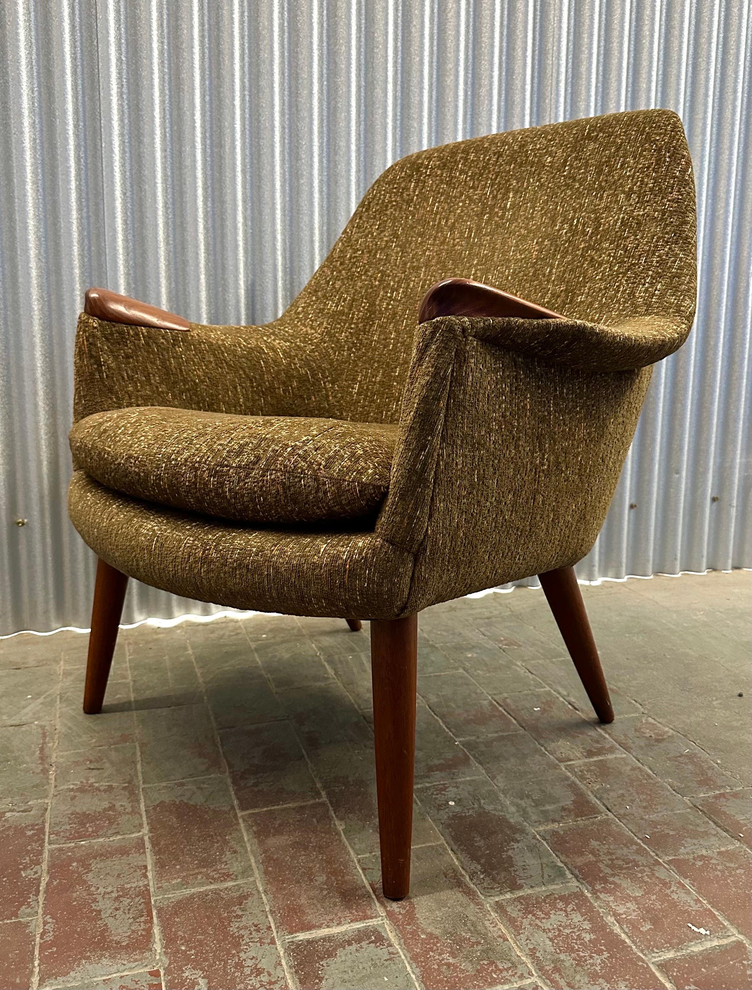 Sexy, quintessential Mid-Century Scandinavian design, reminiscent of Hans Wegner's Mama Bear chair. Beautiful old-growth teak arm rests and legs, with fully padded seat upholstered in the original flecked brown twill fabric.