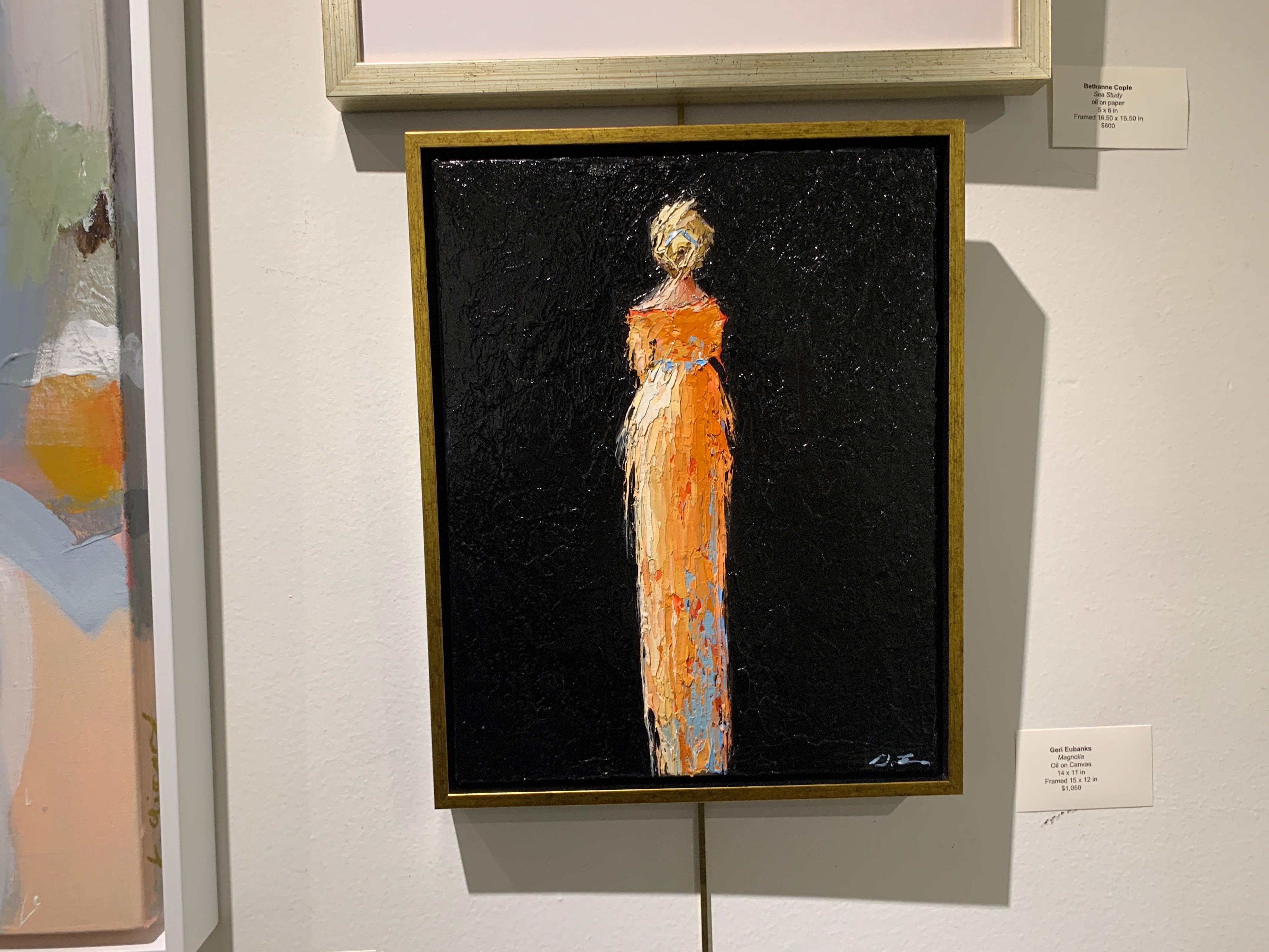 'Magnolia' is a framed Impressionist figurative oil on canvas painting of vertical format, created by American artist Geri Eubanks in 2021. Featuring a palette made of blue, orange, cream black and coral tones, the painting depicts an elegant blond