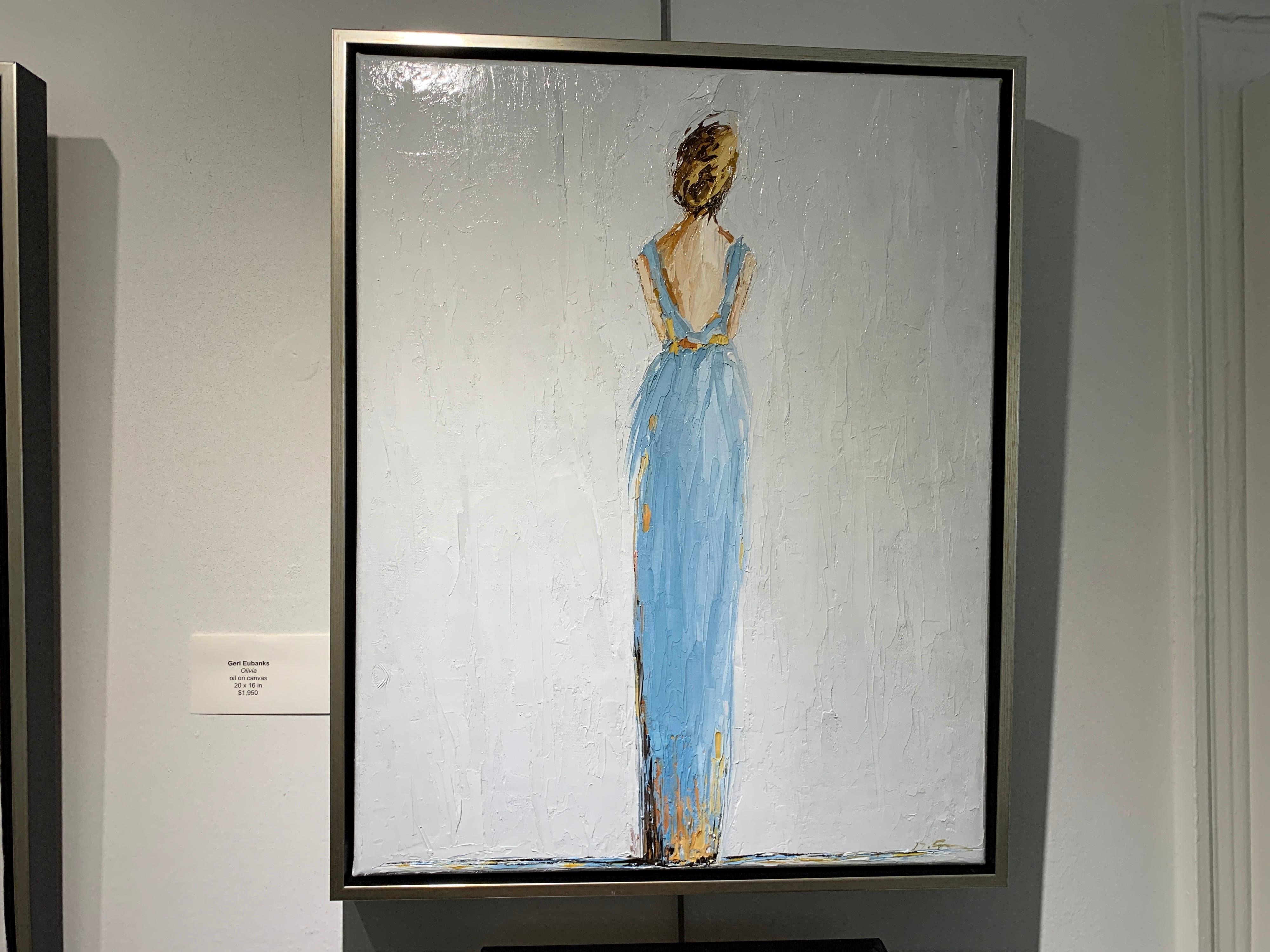 'Olivia', is a vertical framed Impressionist figurative oil on canvas painting created by American artist Geri Eubanks in 2020. Featuring a palette made of sky blue, grey and golden tonalities, the painting depicts a blond-haired woman represented