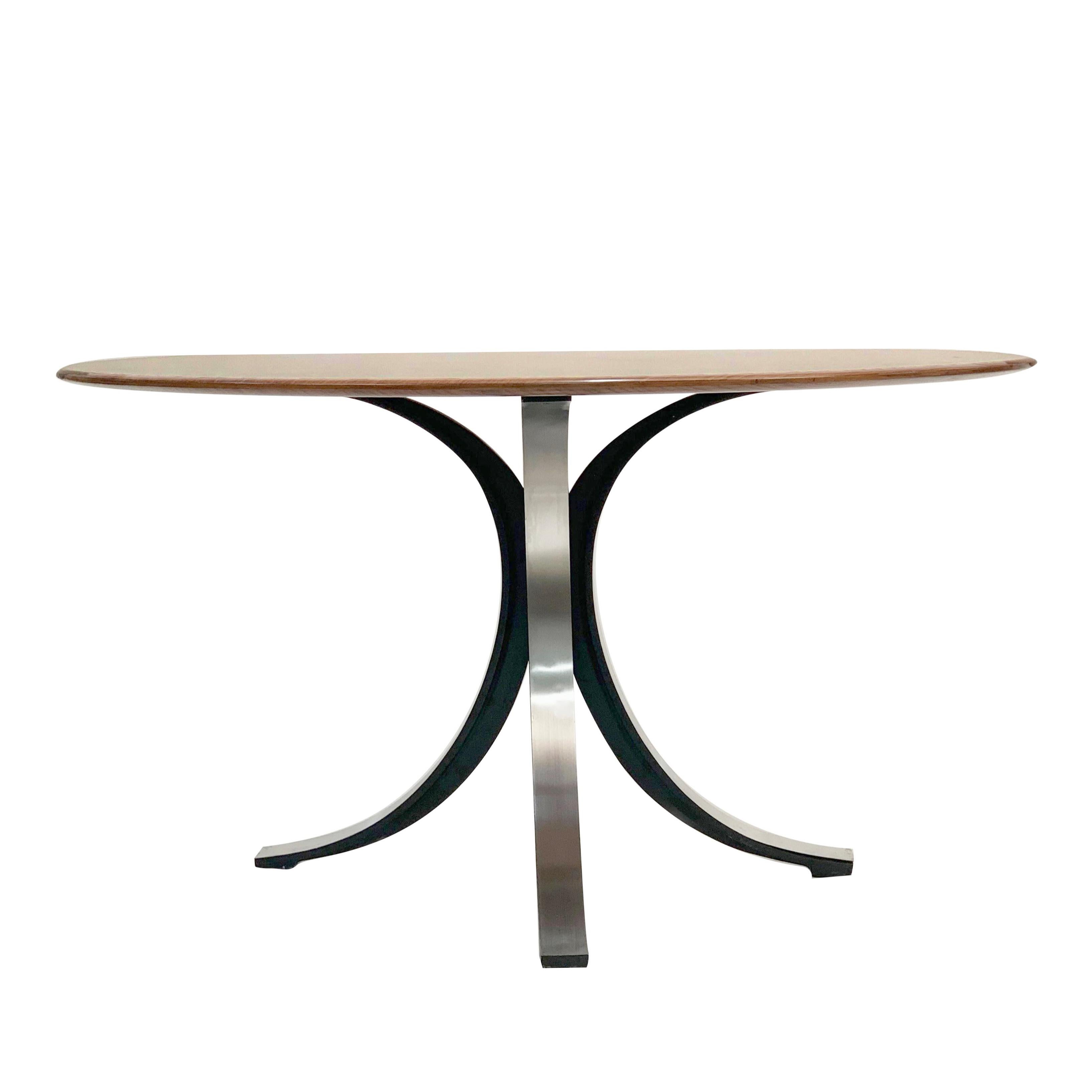 Astonishing midcentury wood and steel T-69 round dining table. This marvelous piece was designed by Eugenio Gerli and Osvaldo Borsani in Italy in 1965.

This dining table comes with the original label (this feature of this table is under the