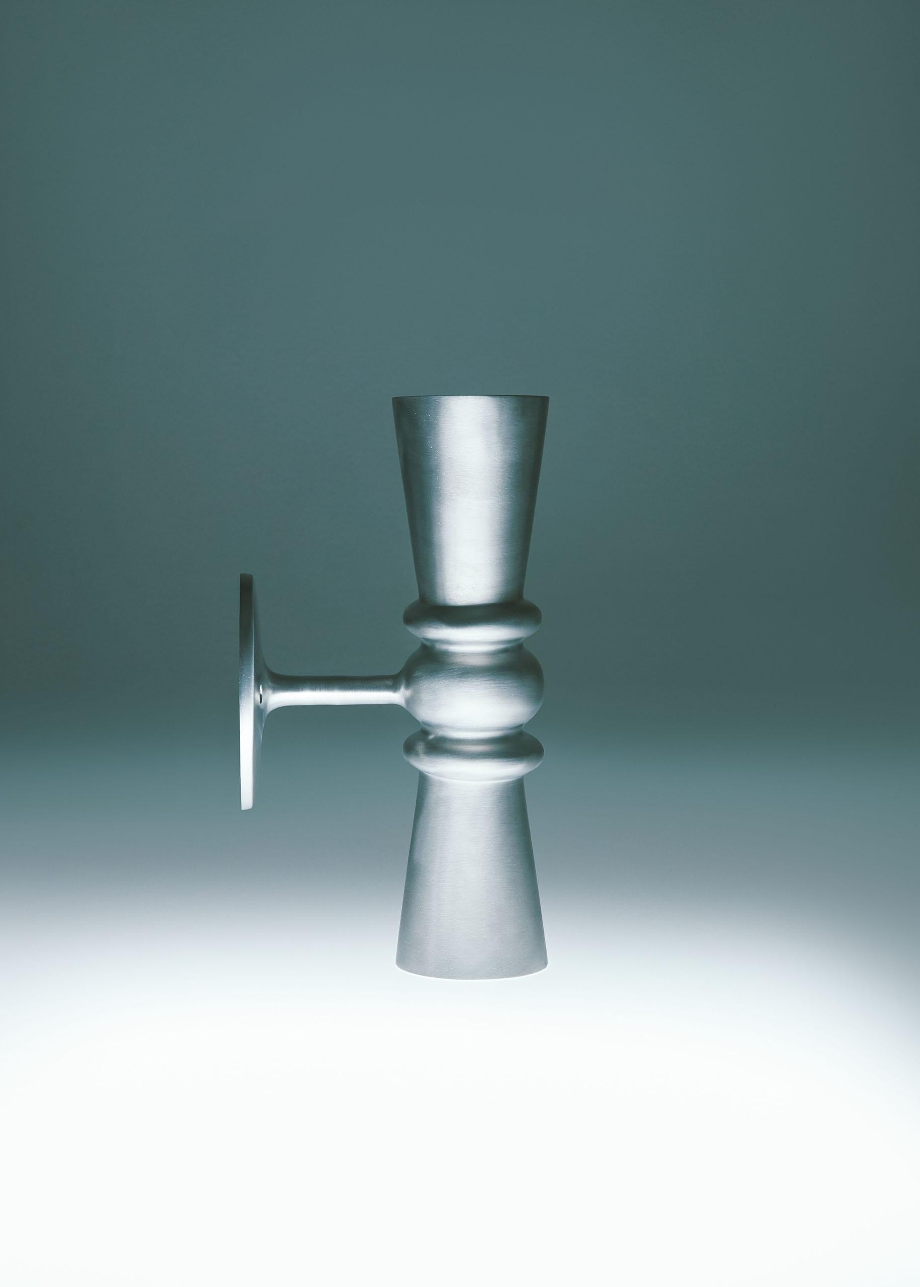 Handmade in solid brass exclusively for Dunlin. 

The Dunlin Germaine Weathered Brass Up-Down Wall Light exudes an elegant and charming presence, adding a touch of sophistication to any living room. Its meticulous craftsmanship, with a keen focus on