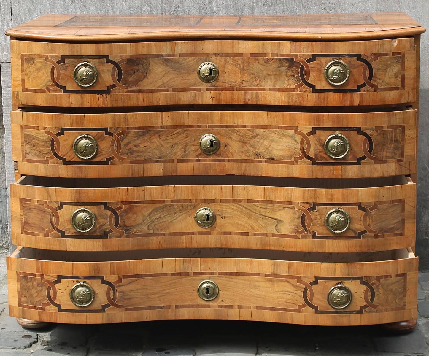 German 18th century walnut, chest of drawers.
The front is curved. Four drawers with marquetry pattern. Fixed handles and locks are in bronze gilt.
The tray is also in marquetry. The feet are in bowls.
Perfect example mixture of Louis XV style