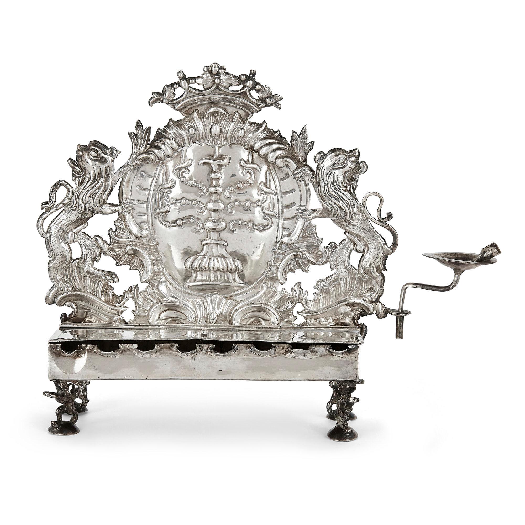 German 18th century silver Hanukkah lamp by Herfurth
German, c. 1760
Height 17.5cm, width 23cm, depth 7cm

This exceptional German Hanukkah lamp was produced in the 18th century by the silversmith Rotger Herfurth. The lamp is designed with a