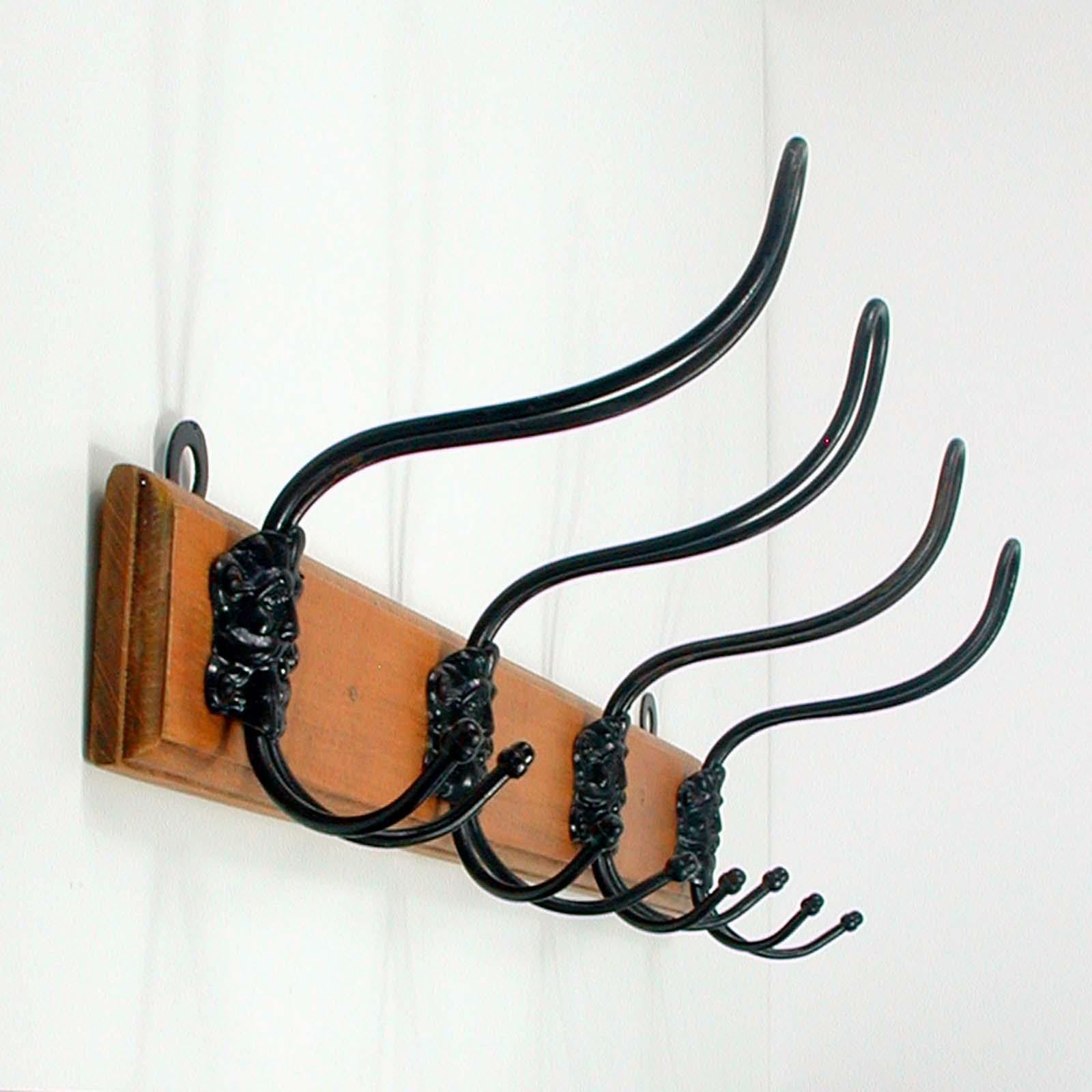 This cottage style coat hanger was manufactured in German in the 1920s. It is made of wood (I assume pine wood) and has got 4 black lacquered hooks with the head of the Greek God Zeus. 

A very unusual piece.