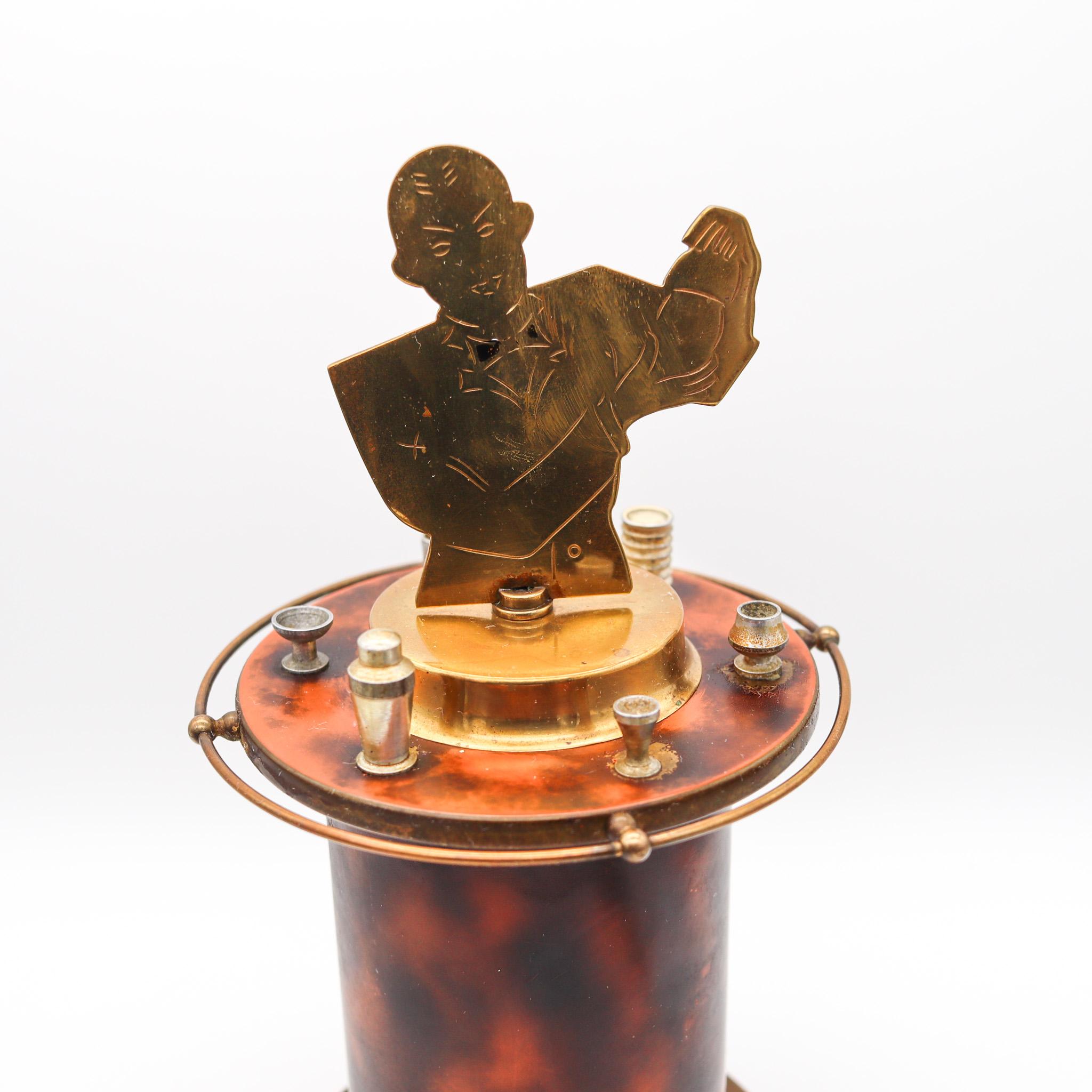 Barman mechanical cigarette dispenser box.

An exceptional and very beautiful desk piece, created in Germany during the art deco period, back in the 1935. This is a rare barman mechanical cigarettes dispenser box with 25 movable elements to fit the