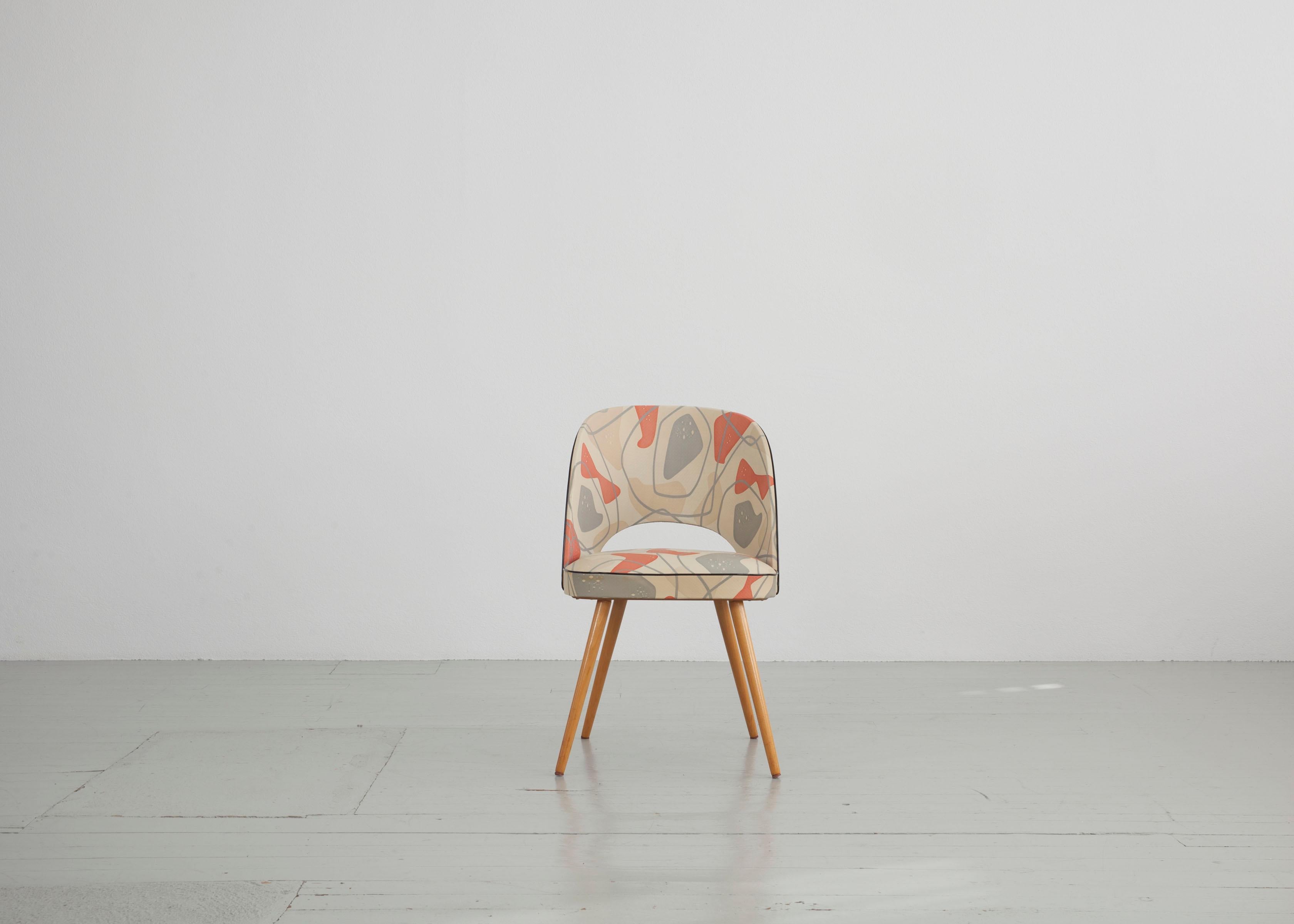 This cocktail chair was made in Germany in the 1950s. It consists of pretty, well-preserved original vinyl upholstery and beech wood was used as material for the frame.