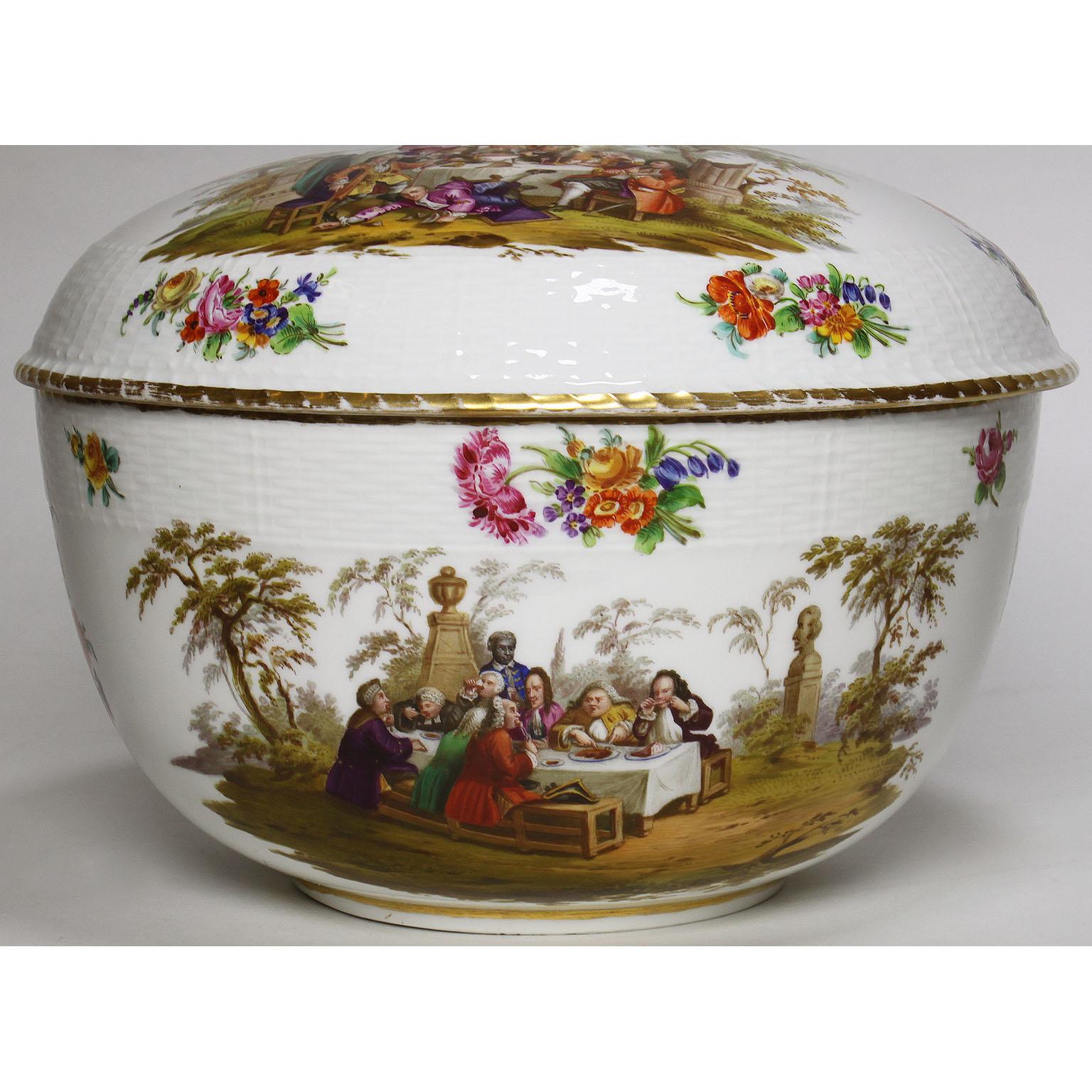 A very fine German 19th century Berlin porcelain covered Tureen, the finial in form of an infant Bacchus on a domed cover with molded band and painted scenes divided by floral sprays, supported by conforming deep bowl. Under-glaze blue scepter mark,