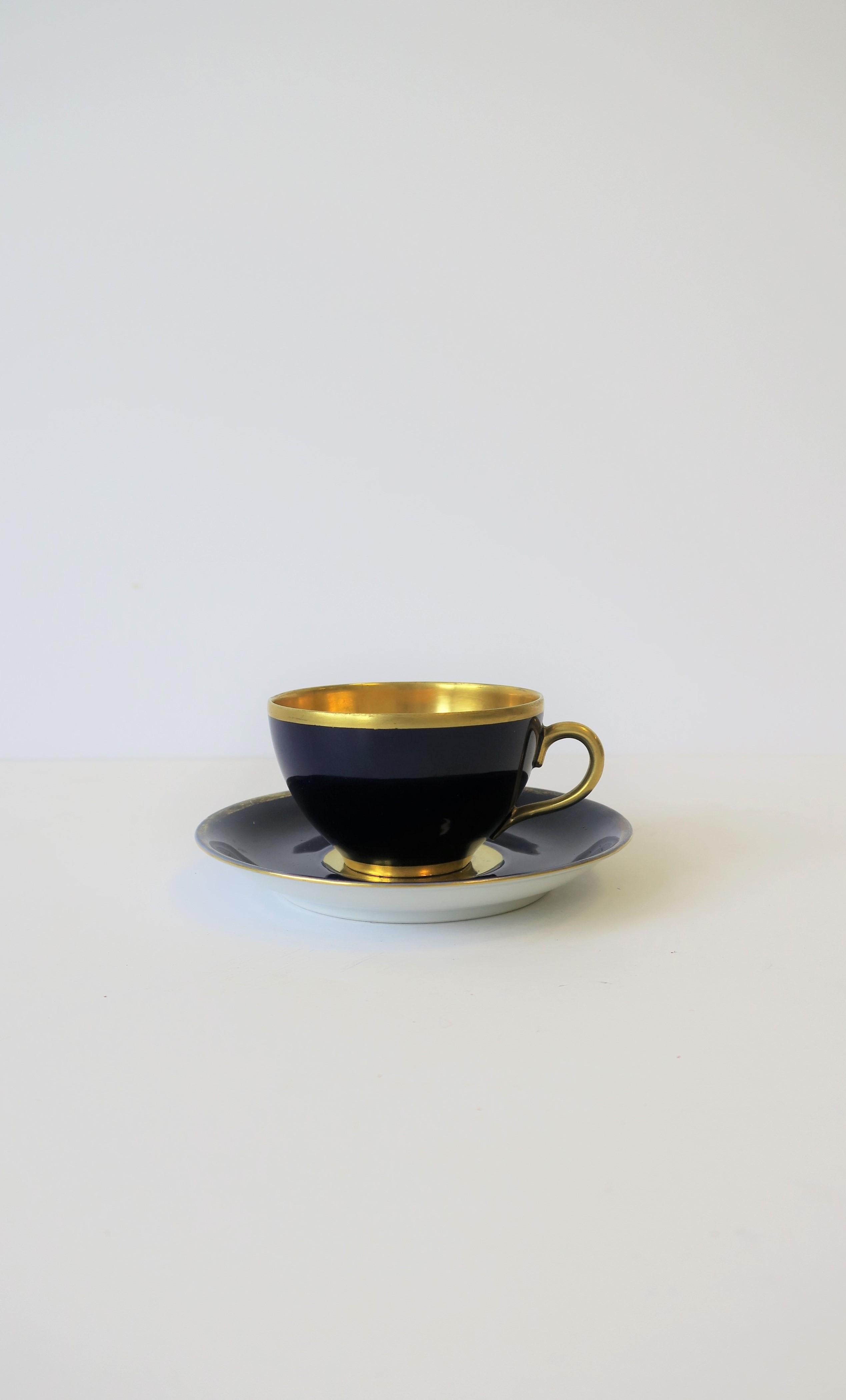 A beautiful 22-karat gold and dark blue porcelain 'demitasse' espresso coffee or tea cup and saucer, Germany, circa early 20th century. 

Measurements include: 
Saucer 4.25 in. diameter
Cup 2.75 in. diameter
Together set is 2 in. H.