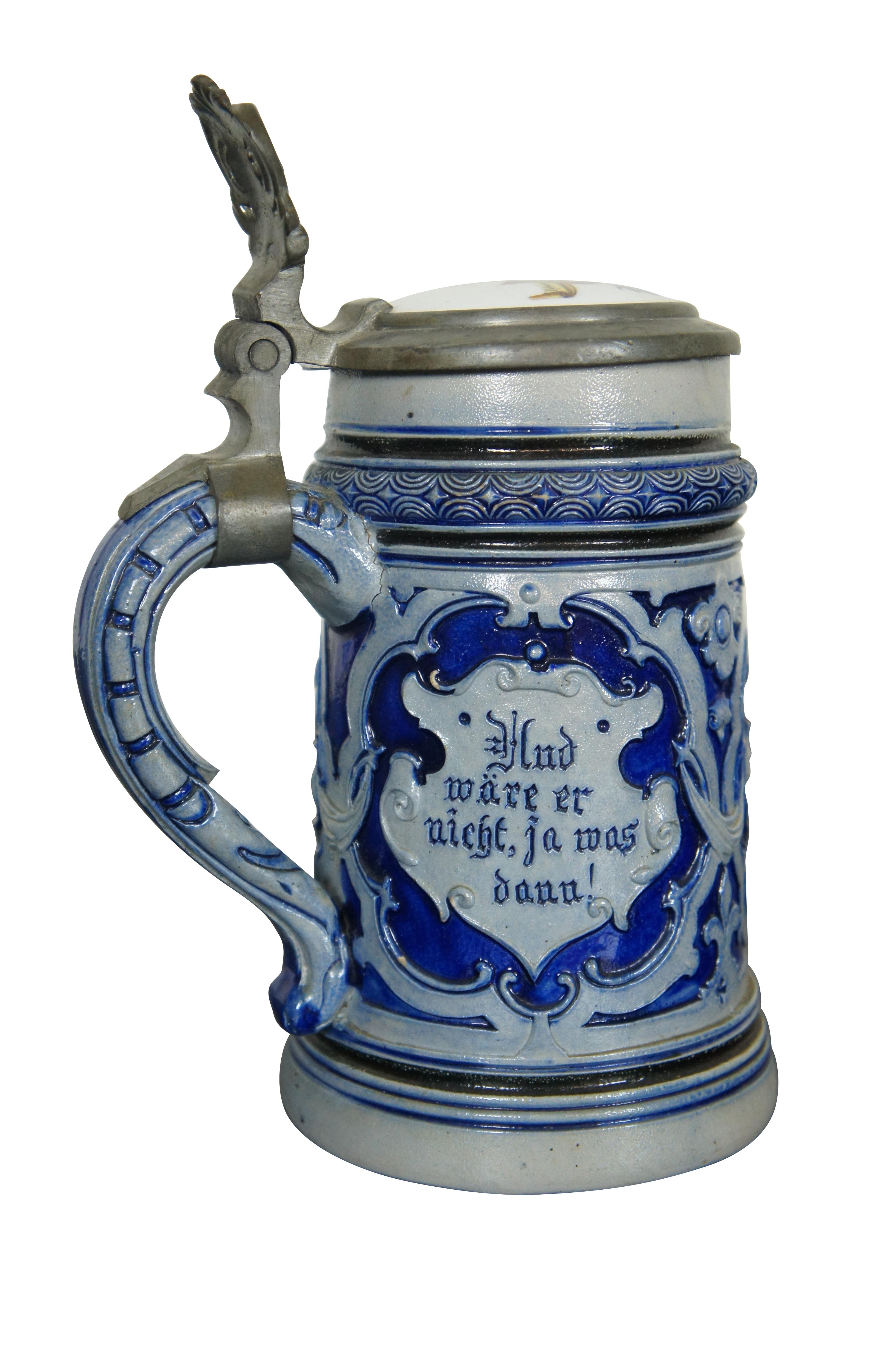 Vintage German beer stein and plaque.  The beer stein features cobalt blue salt glaze with porcelain and pewter lid, heraldic shield / crest with the text: Hud ware er nicht, ja was dann! / Der Durst ist ein grosser Tyran.  Loosely translated to he
