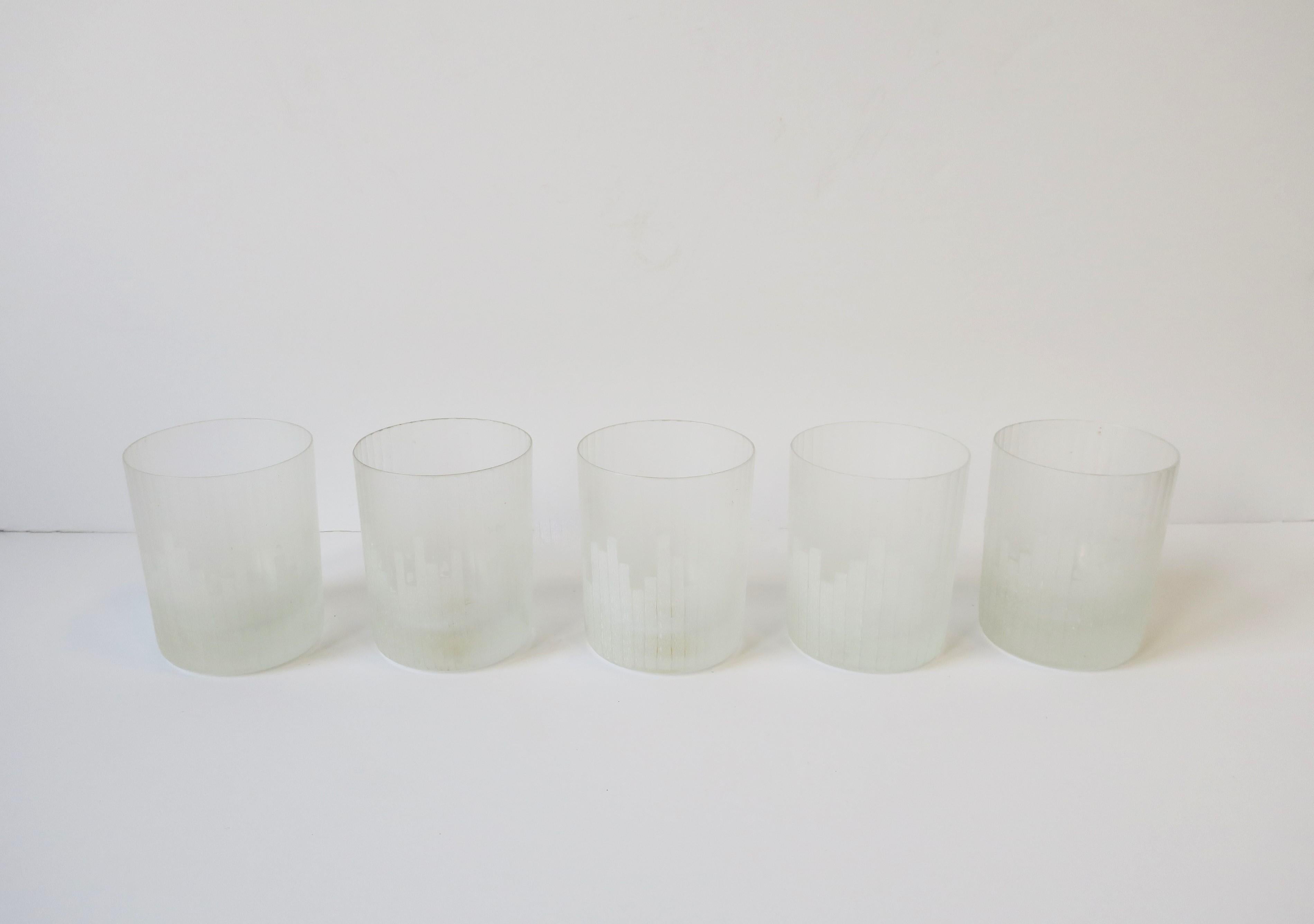 A very beautiful and rare set of five (5) '70s Modern cocktail rocks' glasses by Carl Rotter Lubeck, circa 1970s, late-20th century, West Germany. Glasses have a Modern/Art Deco cityscape design on a matte white glass with fluted design. A great set