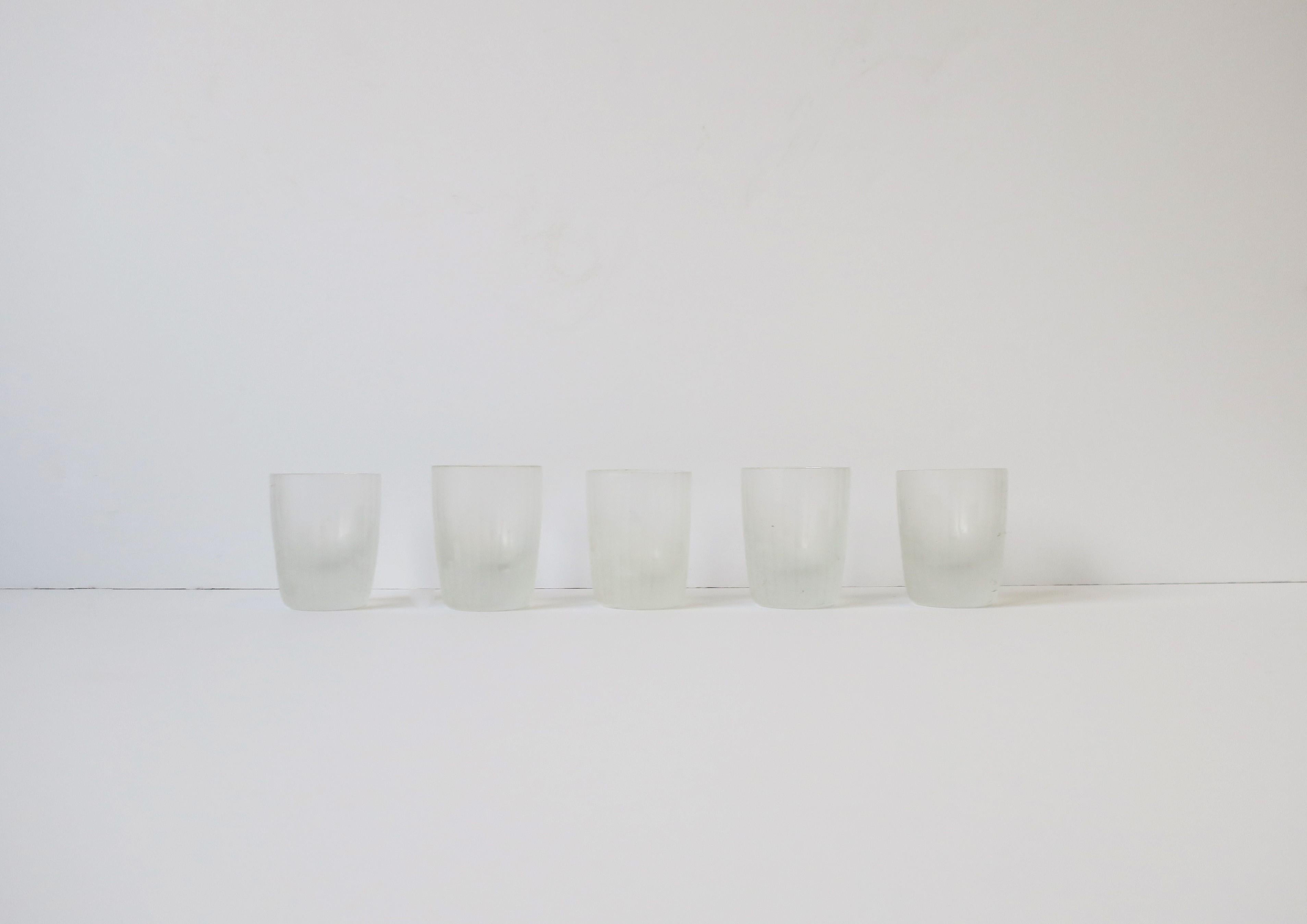 A very beautiful and rare set of five (5) '70s Modern aperitif or shot glasses by Carl Rotter Lubeck, circa 1970s, late-20th century, West Germany. Glasses have a Modern/Art Deco cityscape design on a matte white glass with fluted design. A great