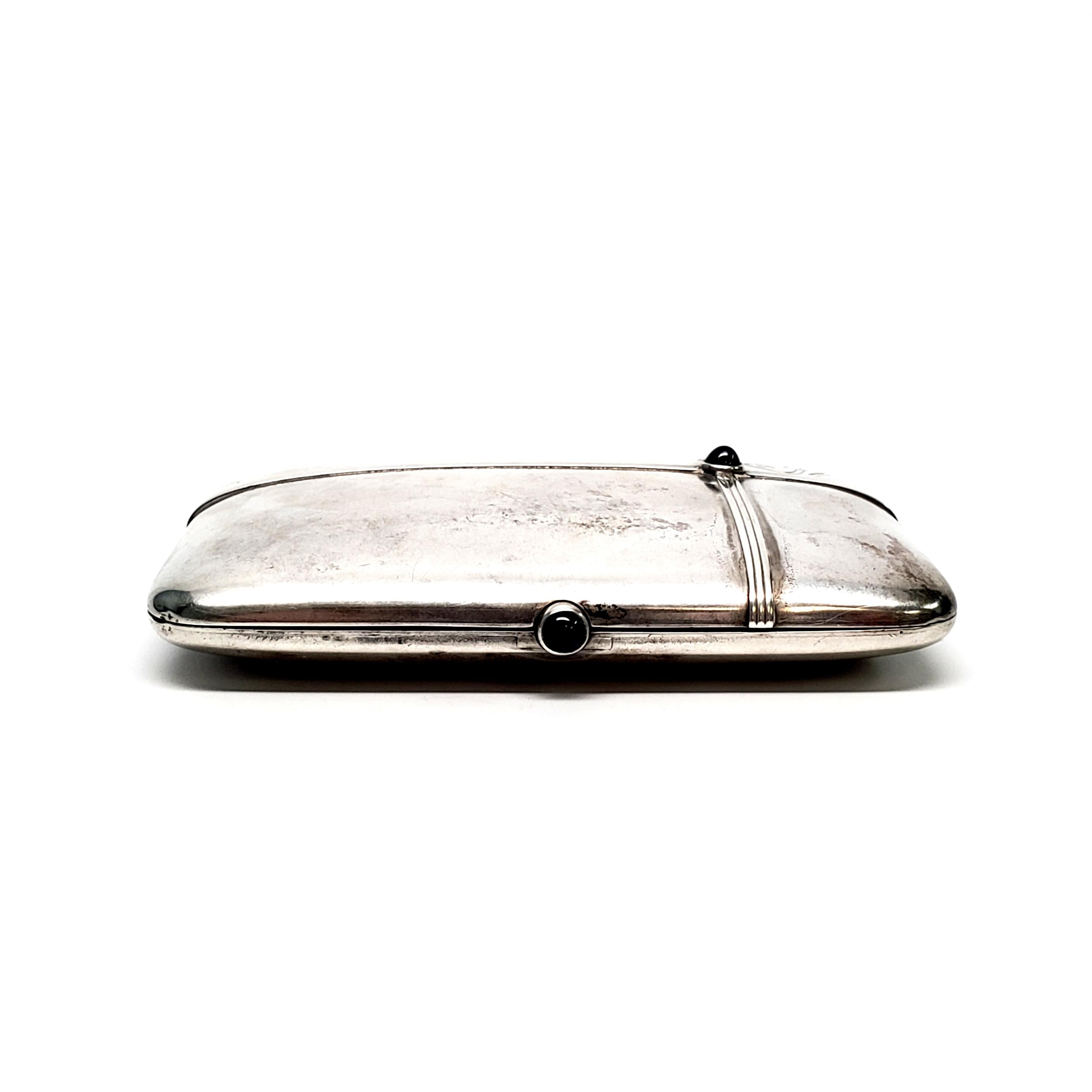 German 800 silver cigarette case.

Lovely piece with ribbed cross design and sapphire cabochons on the front of the case and the push button opening mechanism. Gold washed interior, missing straps, but push button opening is functioning.

Monogram