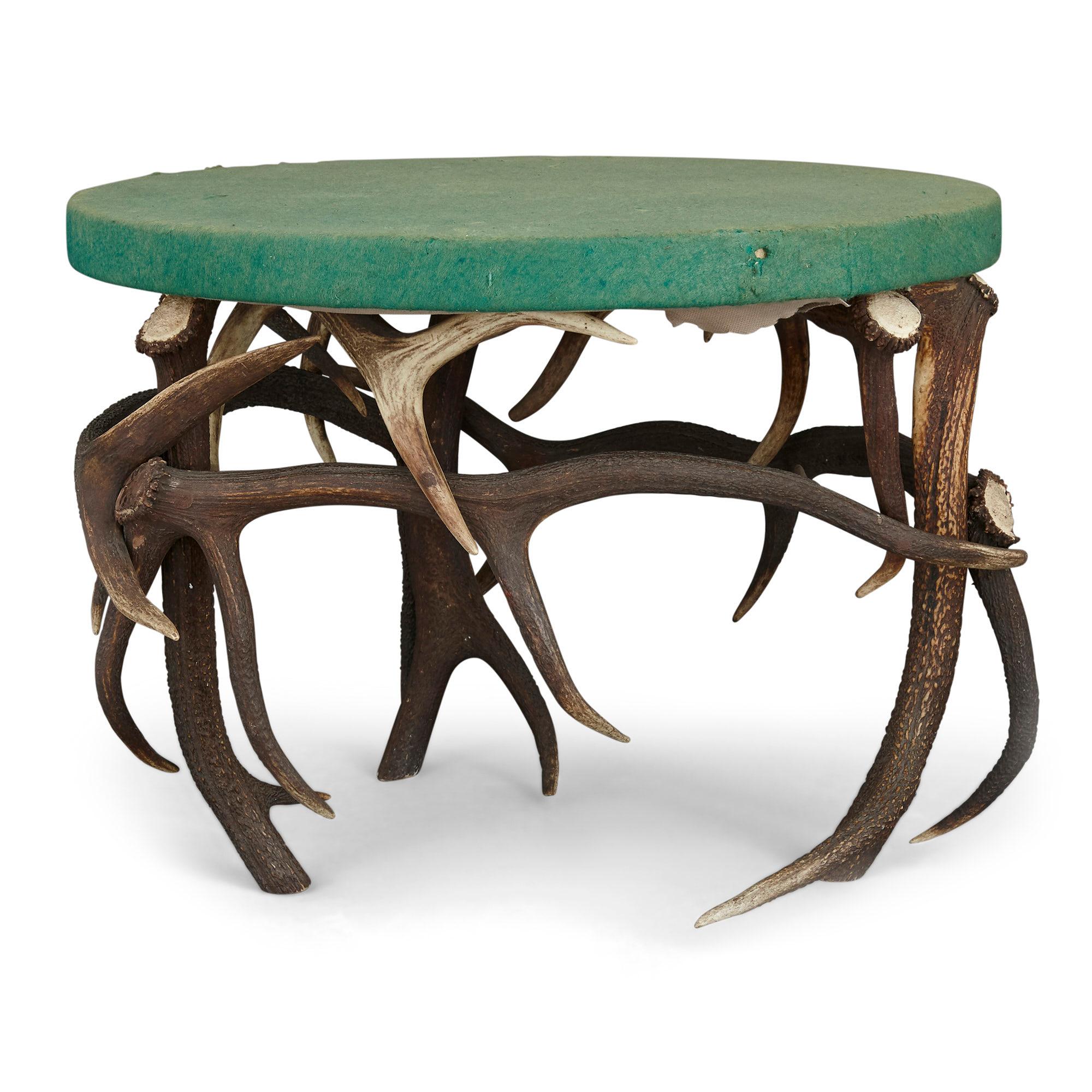 German antler circular coffee table with green felt top.
German, early 20th century
Dimensions: Height 53cm, diameter 72cm

This unusual table, an example of 'antler-seat furniture', was likely crafted in Germany in the early 20th Century. It