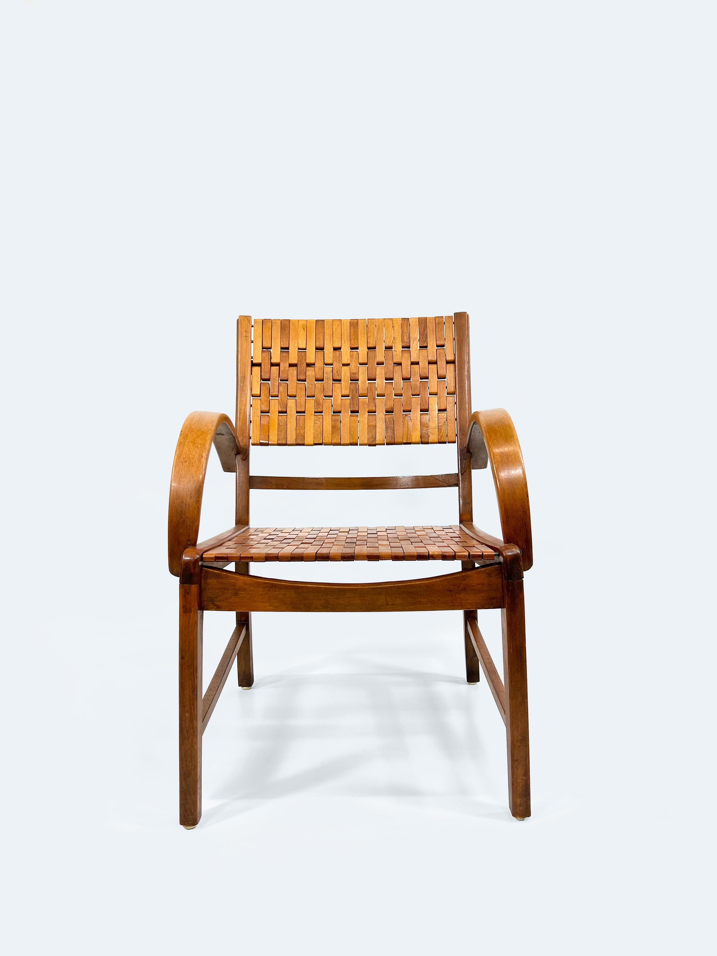 This German Armchair by Gelenka from 1954 is a remarkable example of innovative design and craftsmanship. Made from solid beech wood, stained and lacquered to a transparent finish, it offers both durability and elegance. The chair features a