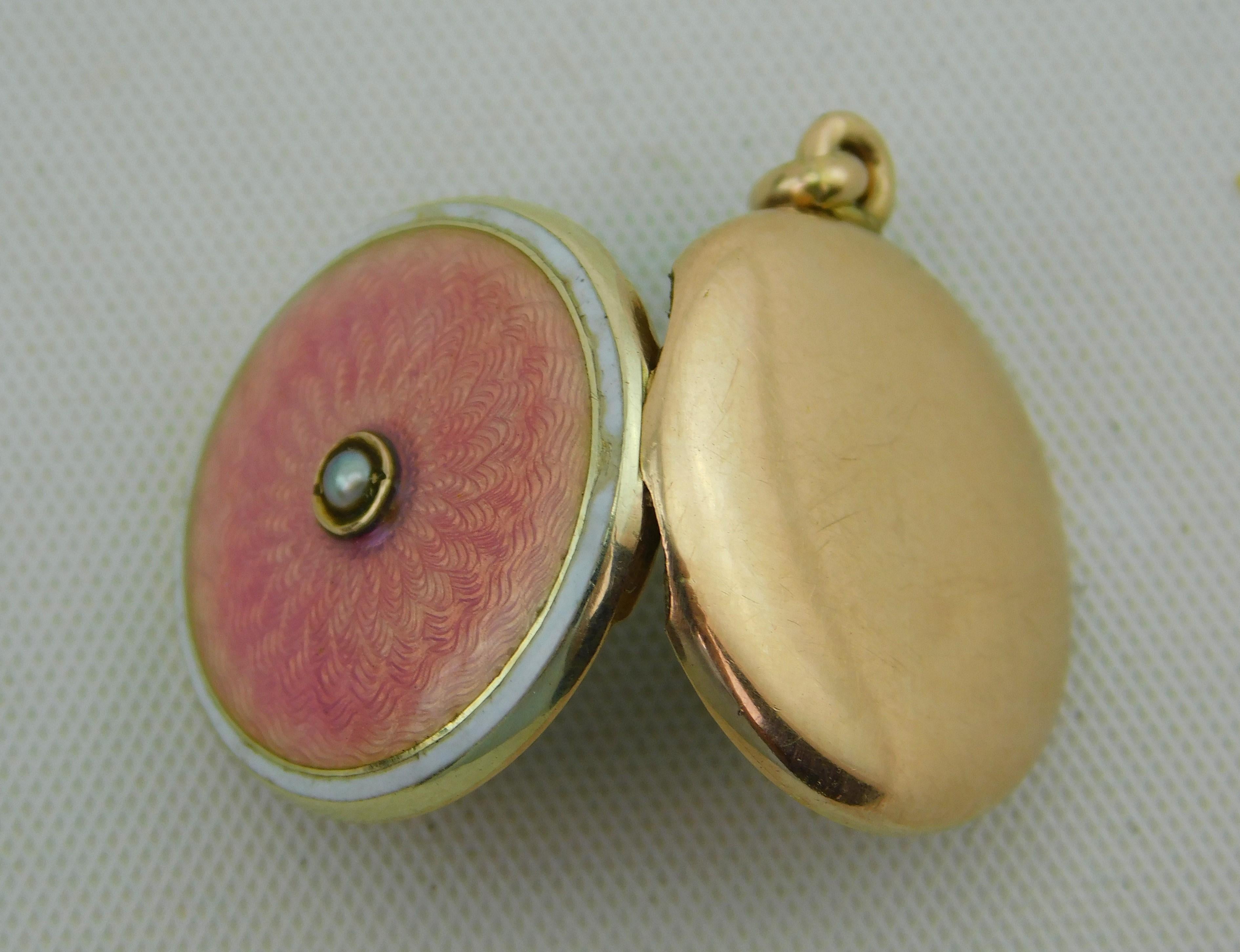 Attributed to German jeweler Ernst Gideon Bek (1872-1945) 10K gold beautiful pink floral design enamel locket pendant, with a single pearl in the middle and two black and white pictures of a couple inside.  Measure's 1.6 cm round, 2 cm to top of