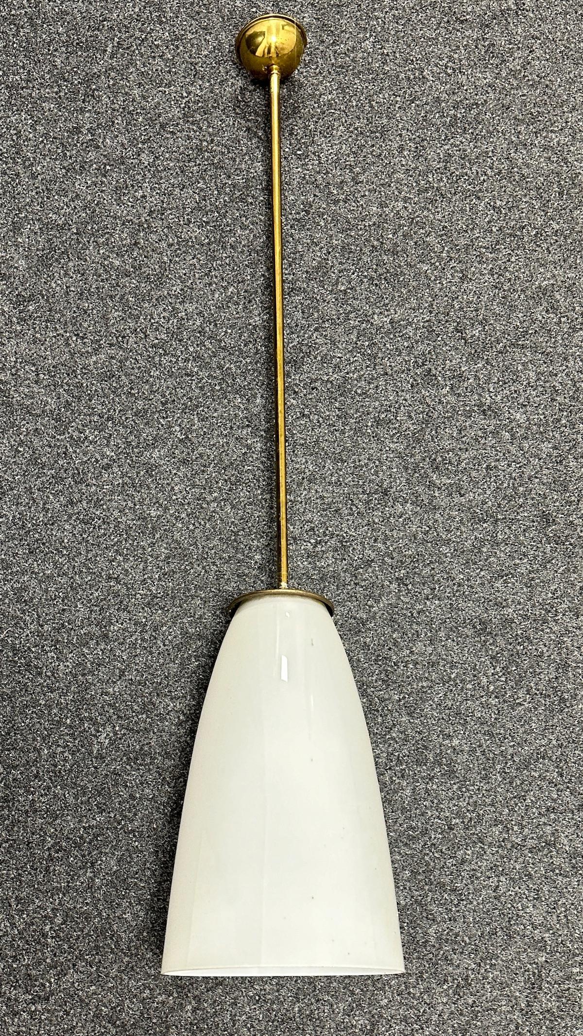 This Art Deco Bauhaus Style chandelier was made in the 1930s in Germany. It is made of a brass frame and a opaline glass shade. The Fixture requires an European E27 / 110 Volt Edison bulb, up to 100 watts. The Glass part is approx. 15.75
