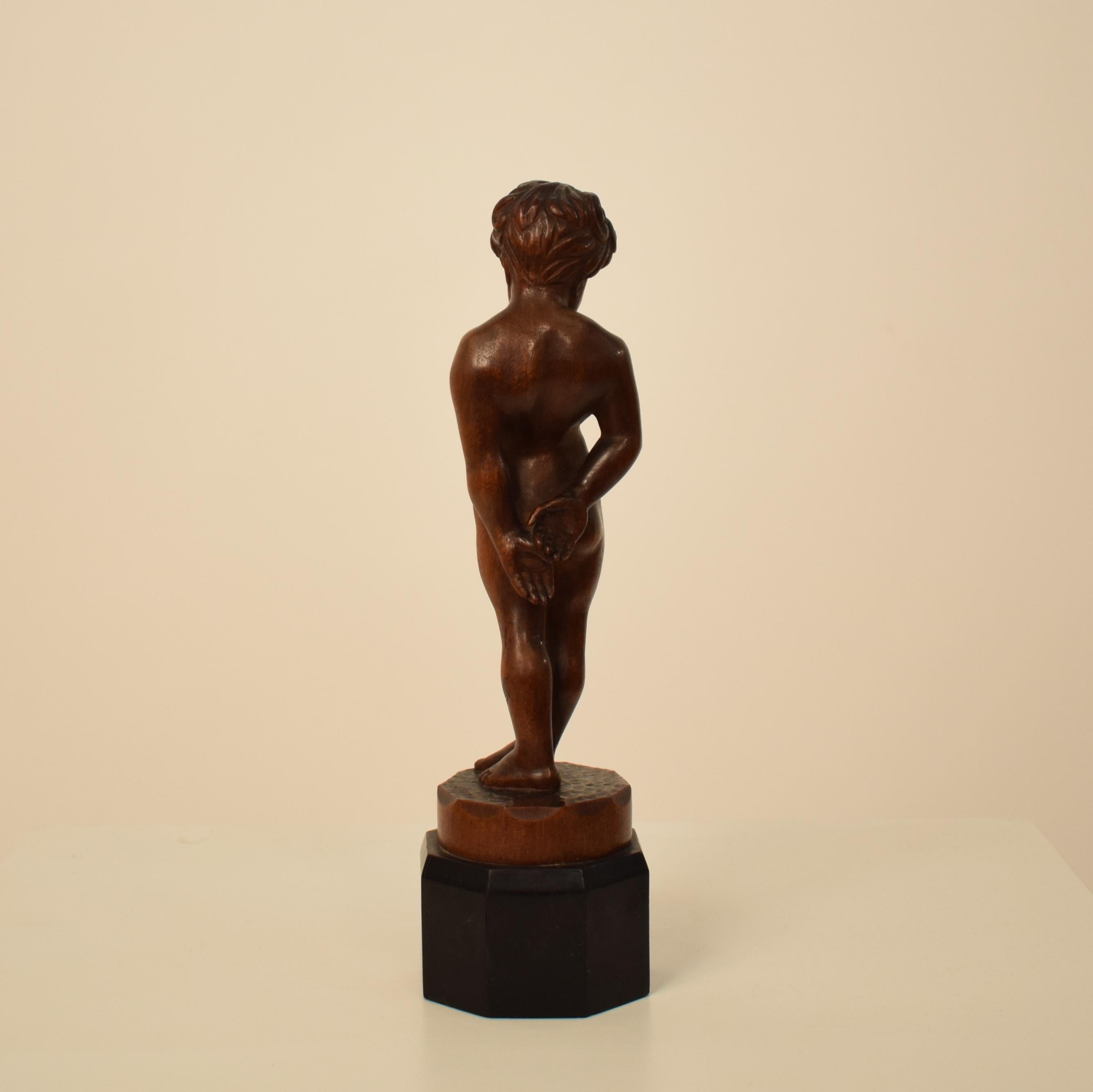 German Art Deco Carved Wooden Walnut Sculpture of a Boy with Ebonized Base 1927 1