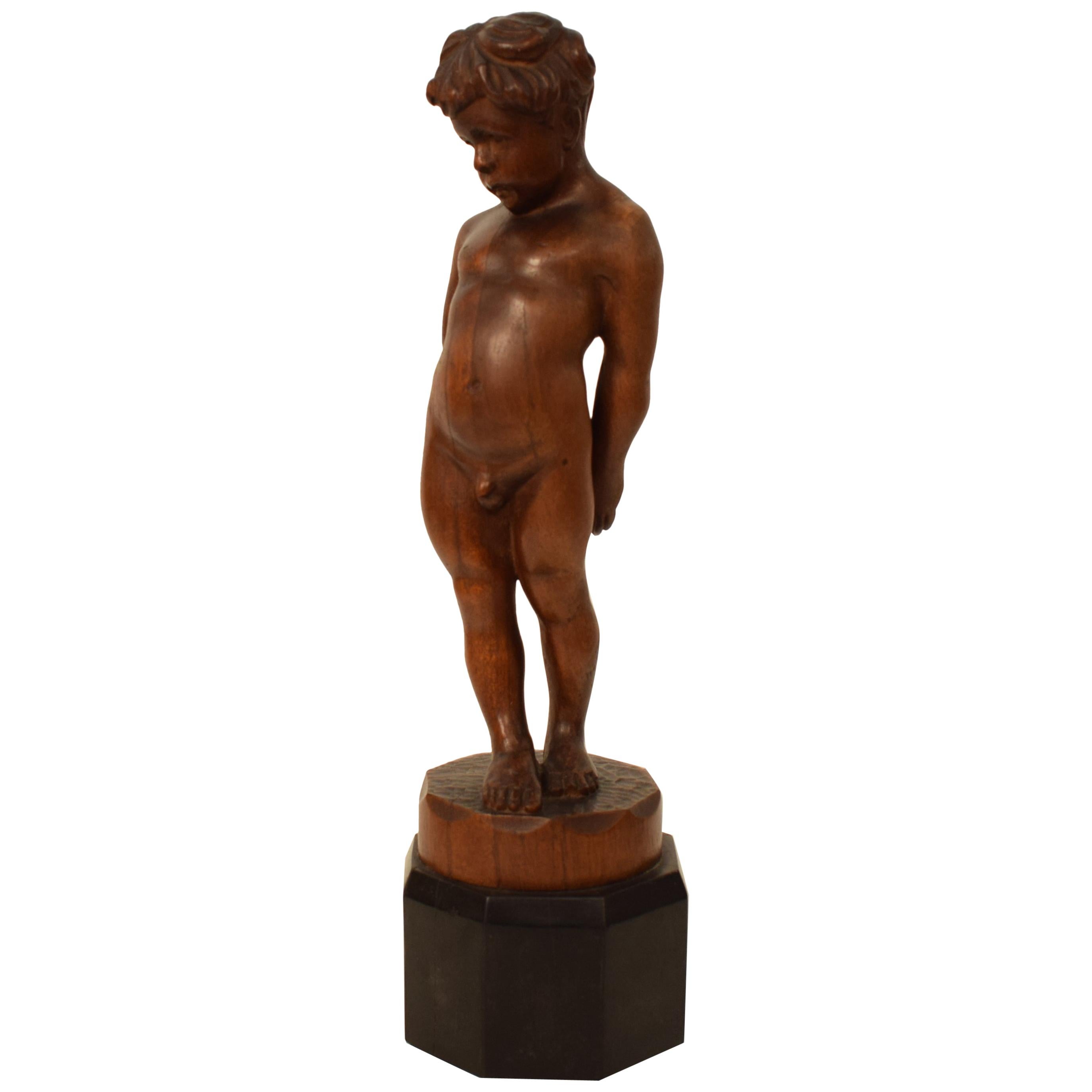 German Art Deco Carved Wooden Walnut Sculpture of a Boy with Ebonized Base 1927