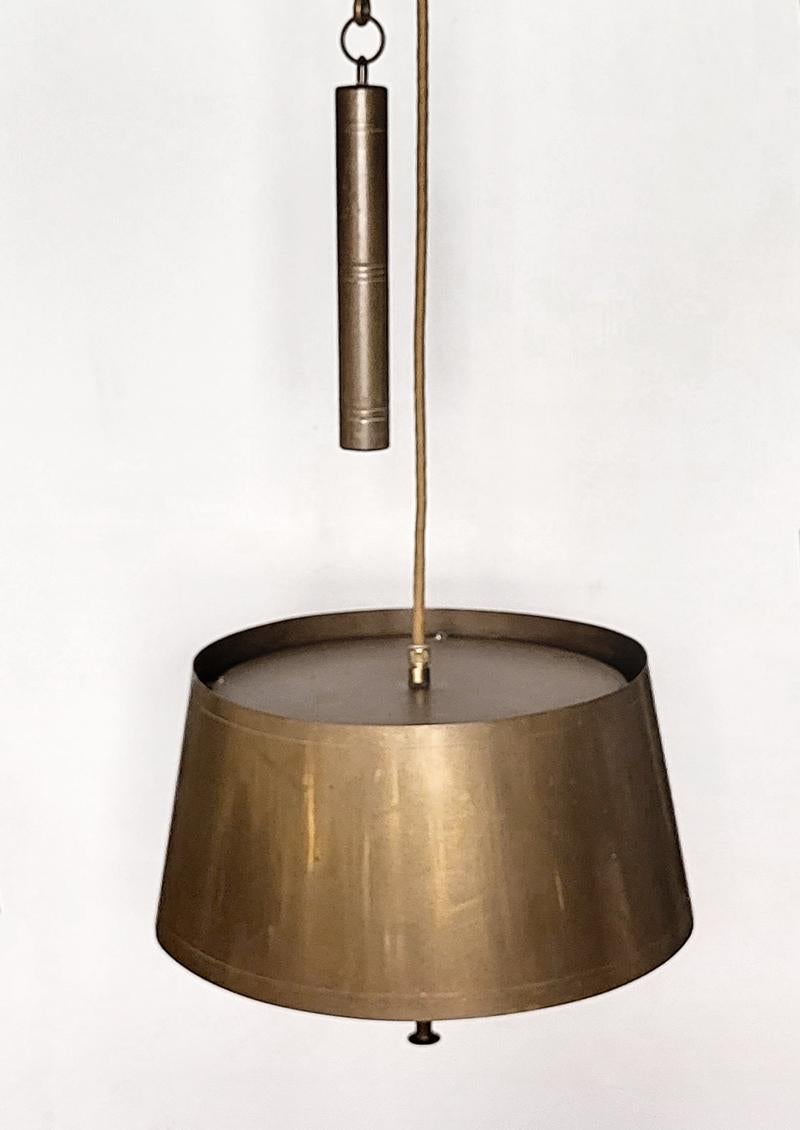 Art Deco adjustable solid brass pendant light.
Germany, 1920s-1930s
Lamp sockets: 2x