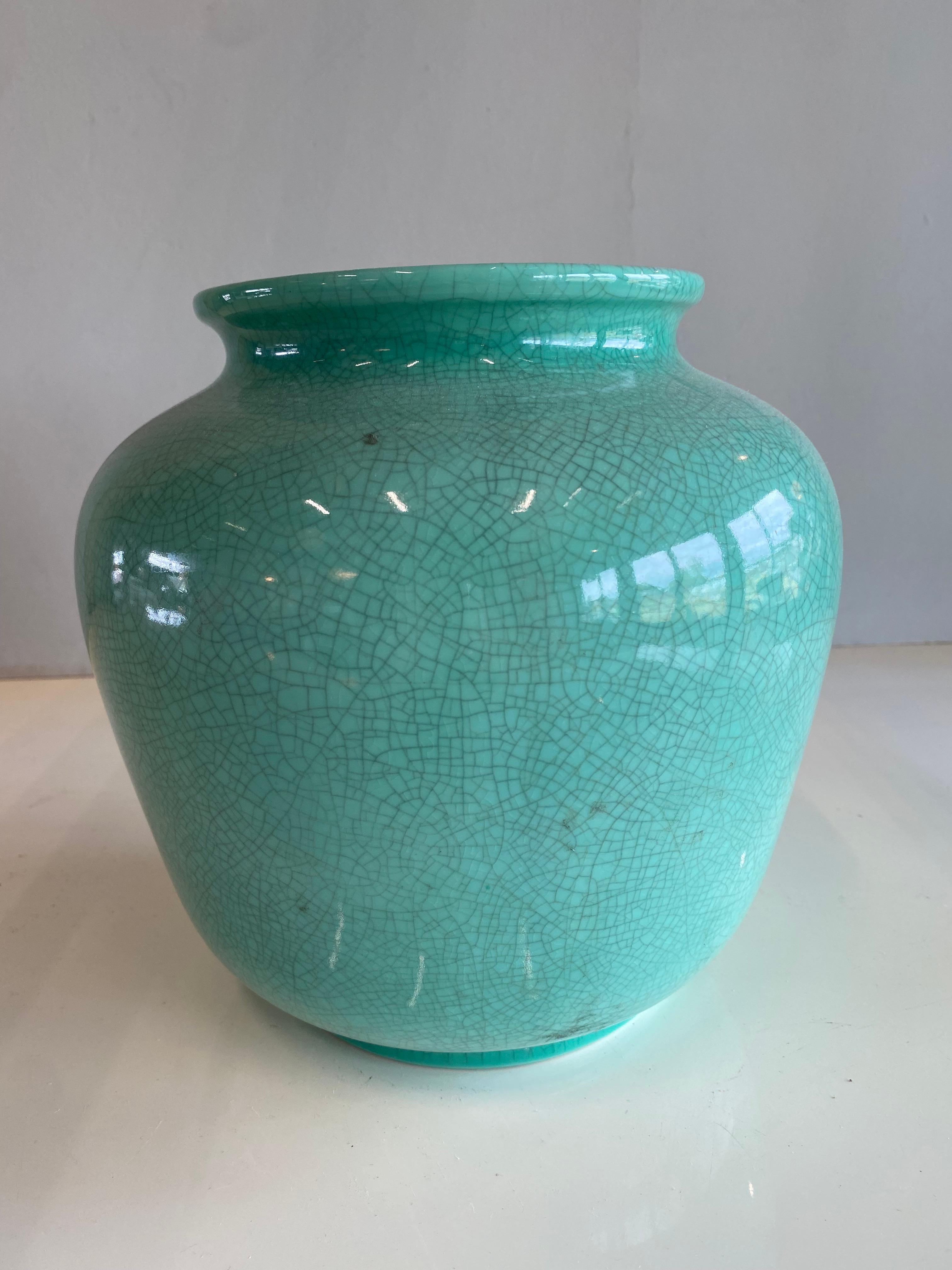 This light green Art Deco vase comes from Germany and is from the 1920s. It is an eye-catcher that brings fresh accents to any interior, even without flowers. The pastel green tone can be combined very well with modern elements, the craquelure makes