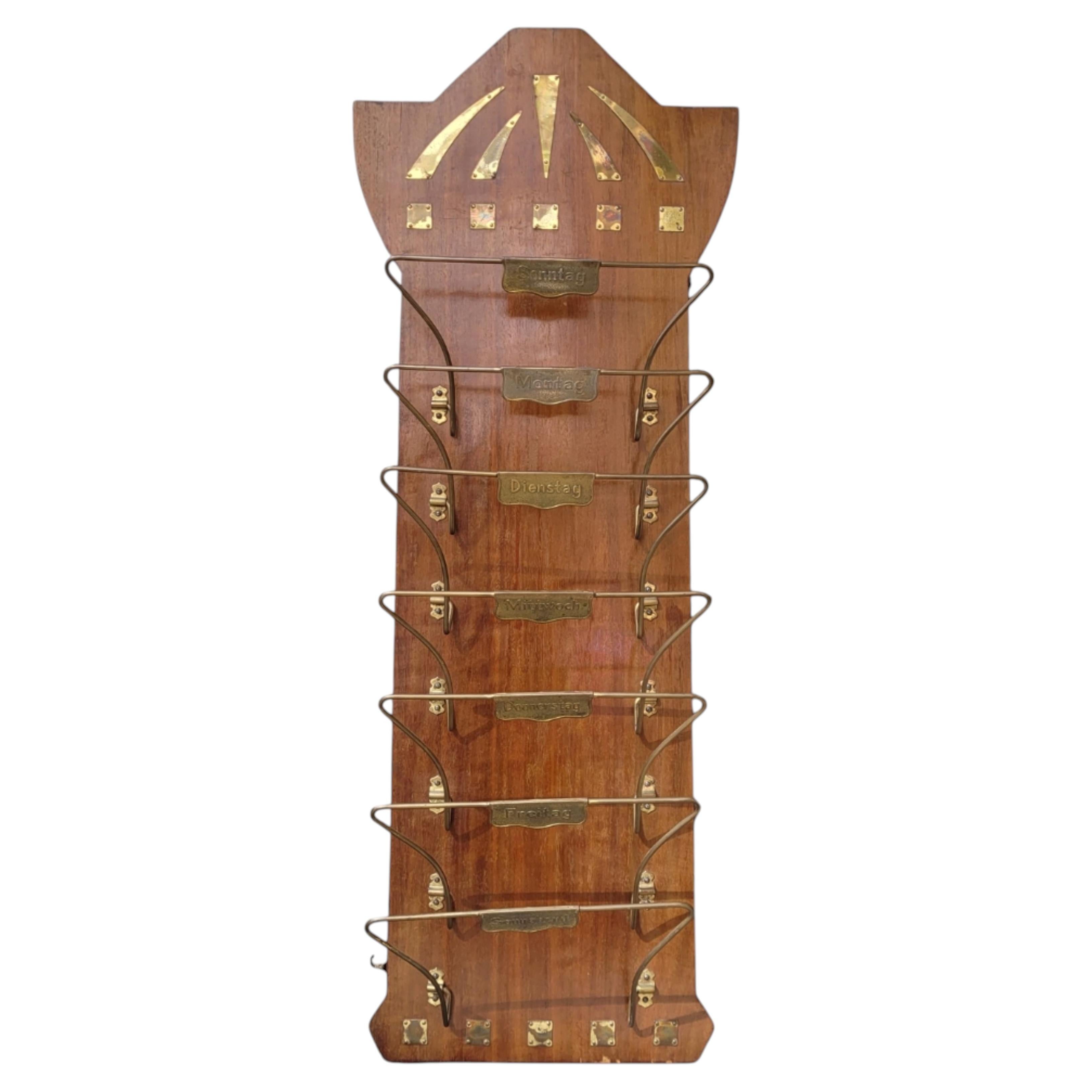 German Art Deco magazine rack in wood and bronze, with the days of the week.