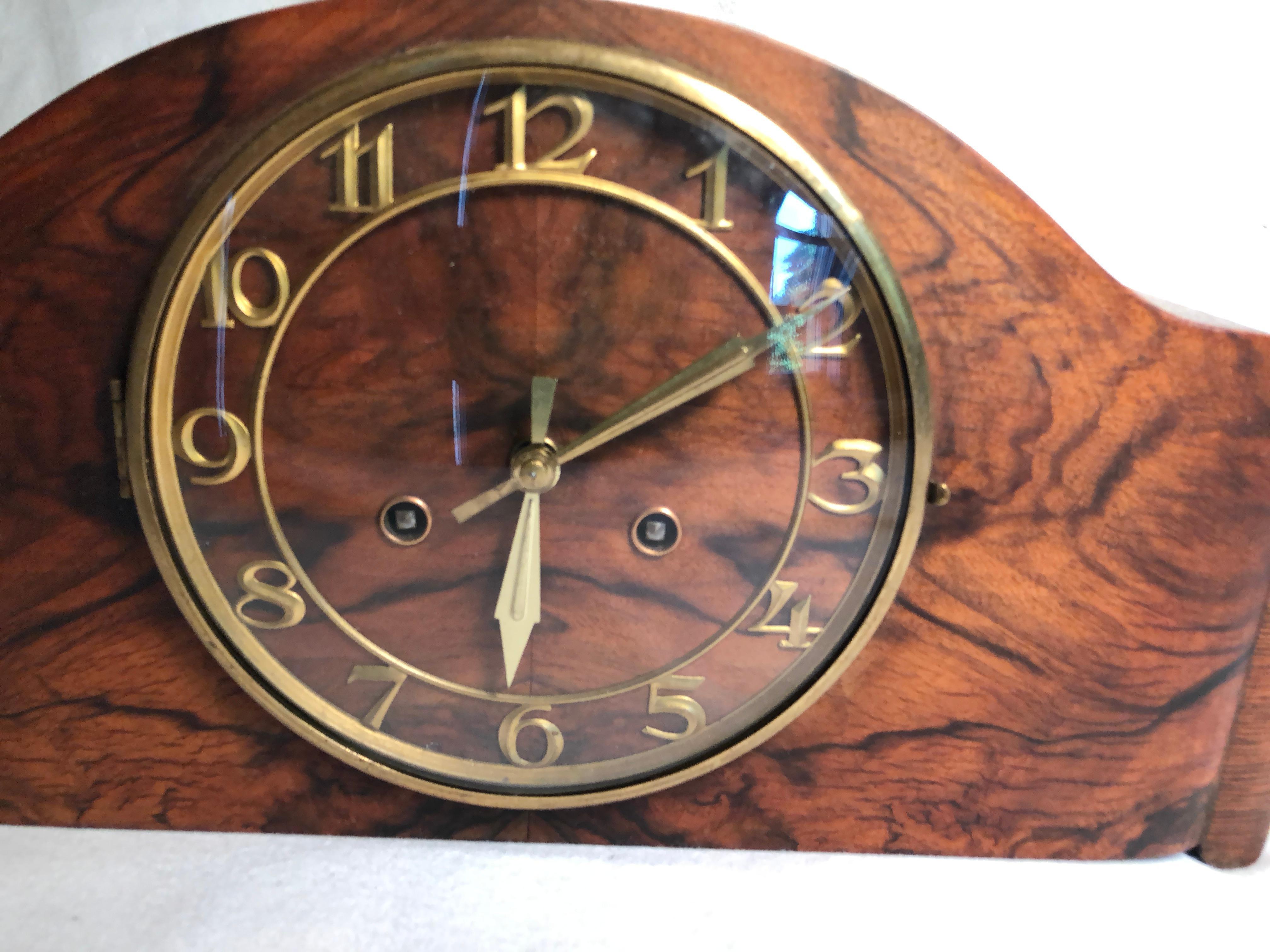 This wonderful clock has the most beautiful patterned wood veneered front. What makes this clock so special is that the wood pattern is only interrupted with 12 numbers and two hands. It has been cleaned and inspected by a certified horologist and