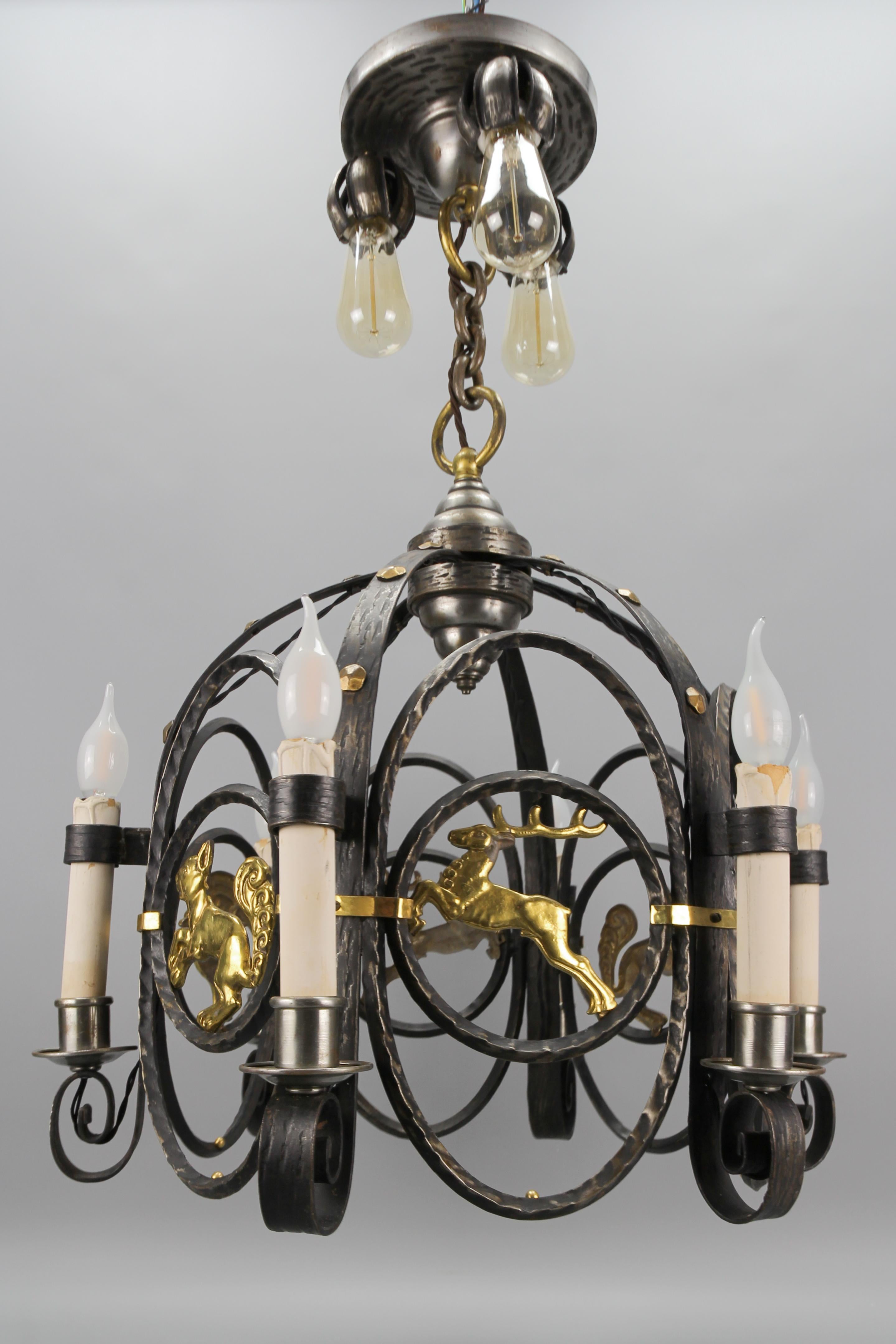 German Art Deco Nine-Light wrought iron and brass chandelier with animals, the 1920s.
This impressive German Art Deco period chandelier features a beautifully shaped wrought iron frame, adorned with decorative details made of brass and patinated