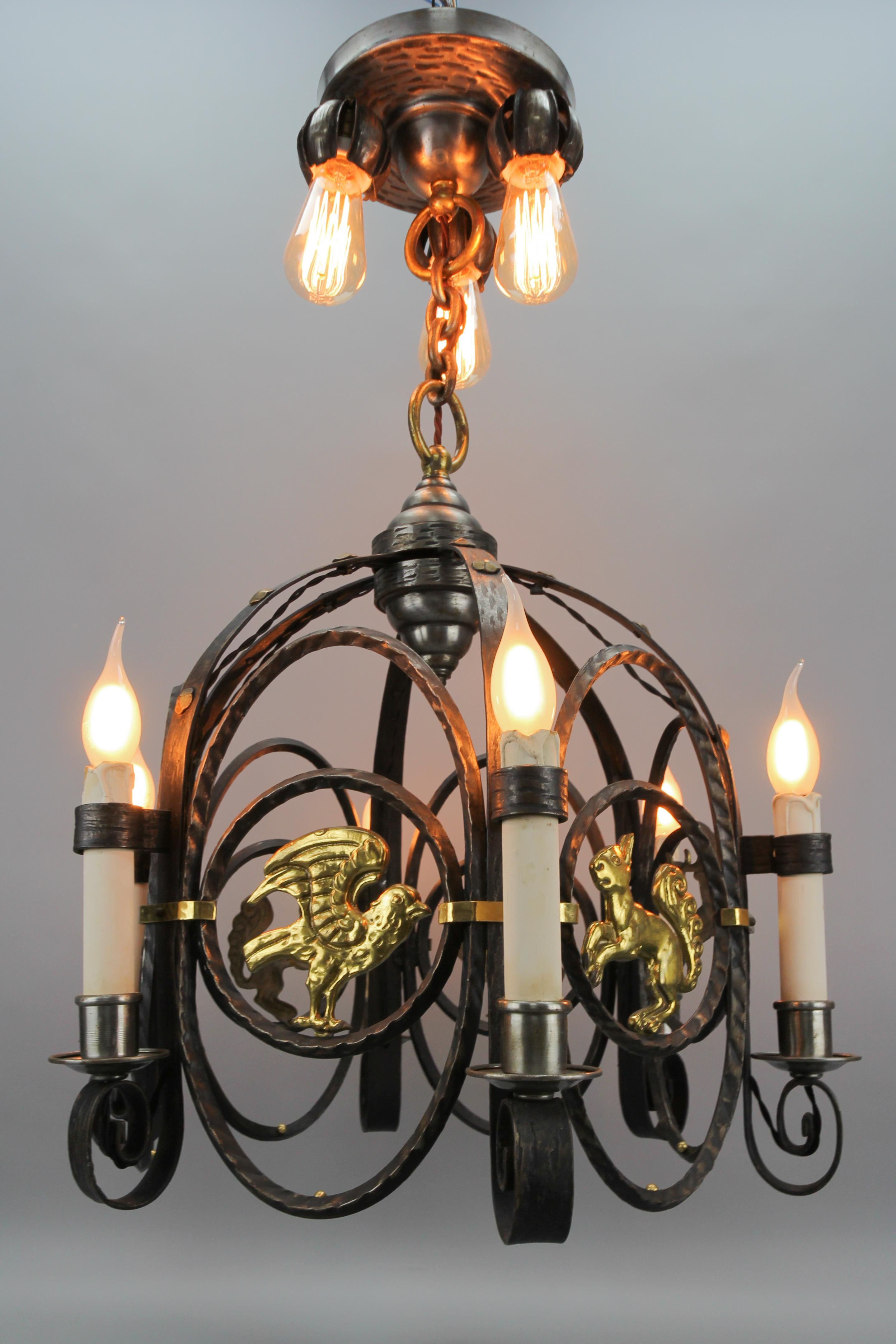 Patinated German Art Deco Nine-Light Wrought Iron and Brass Chandelier with Animals, 1920s For Sale