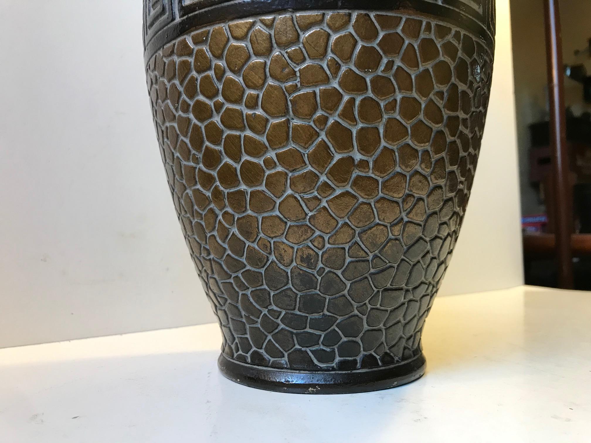 Tall and decorative German vase with great Art Deco styling. Architectural details, snake skin or tiles imita and bronze glaze. Its has an unidentified marking beneath its base.