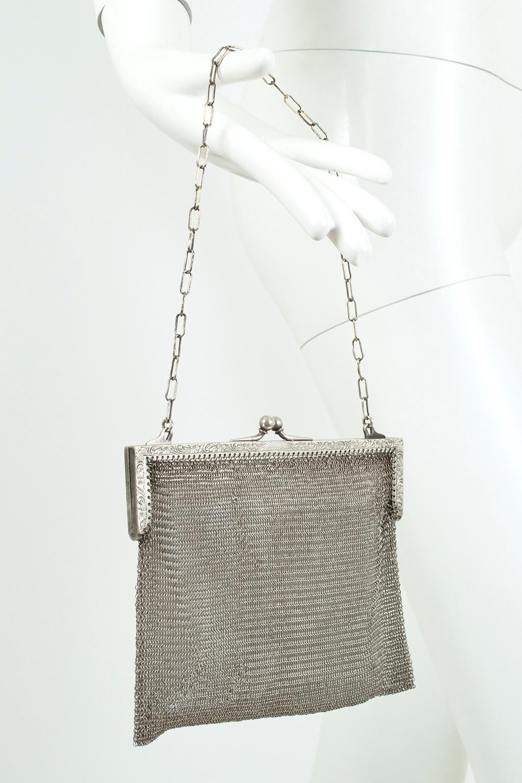 In liquid silver mesh, this semi-transparent evening bag looks like Medieval chain mail and wears almost as powerfully. Its patterned Art Deco top frame, hairpin chain handle and pouch polish to a gleaming finish to create the perfect accompaniment