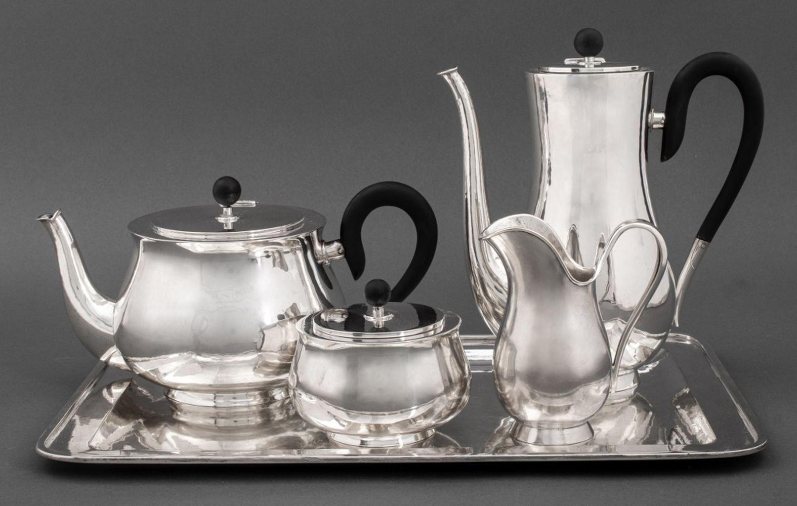 Art Deco style 800 silver tea and coffee service set consisting of five pieces (tray, pot, coffee pot, sugar jar, creamer jug). The pots include ebonized finials and handles. They are marked with crescent moon and crown which verifies the purity of