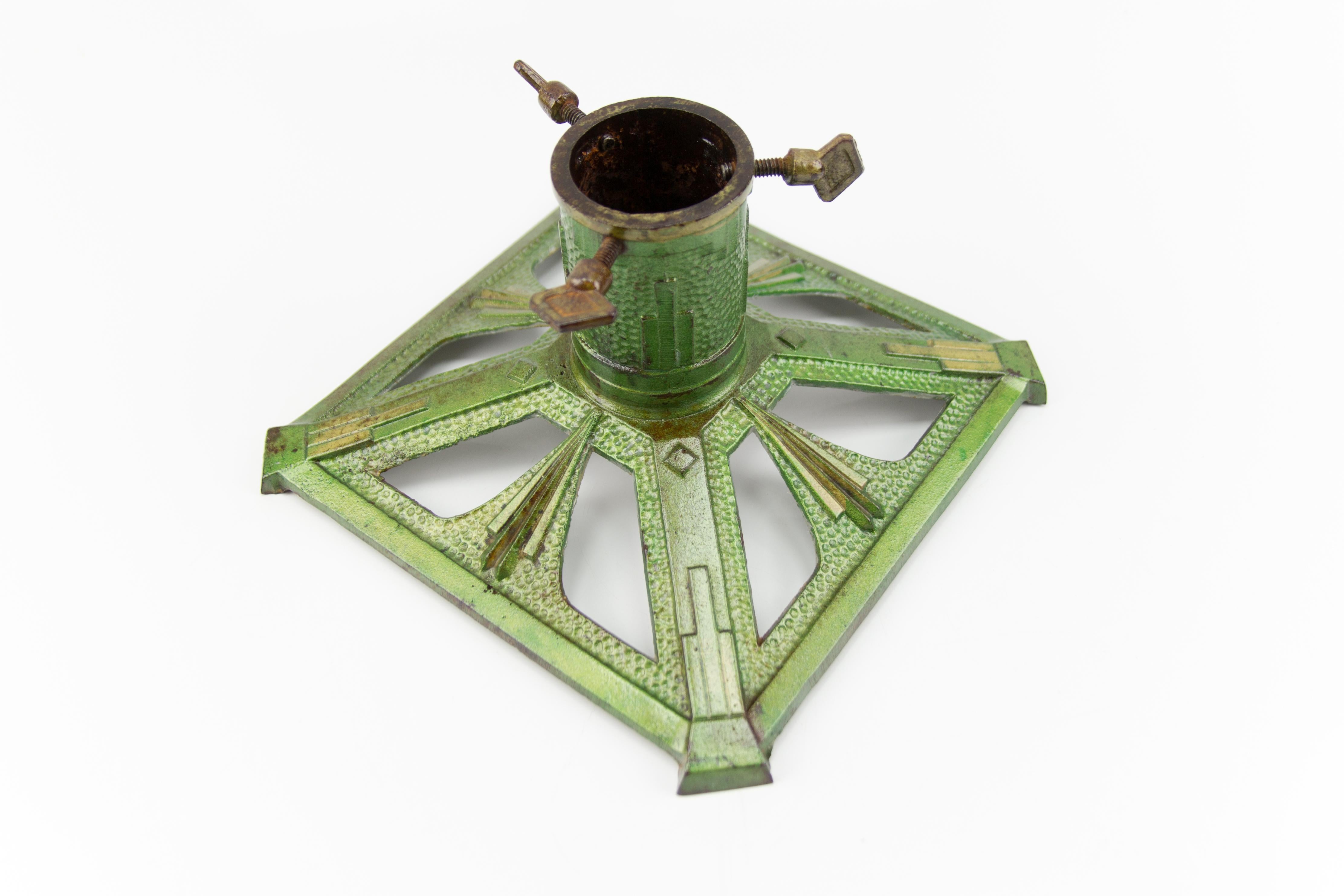 Art Deco style green and golden color cast iron Christmas tree stand, Germany, 1950s.
Dimensions:
Height 13 cm / 5.11 in, width 23 cm / 9.05 in, length 23 cm / 9.05 in, depth 8 cm / 3.14 in.