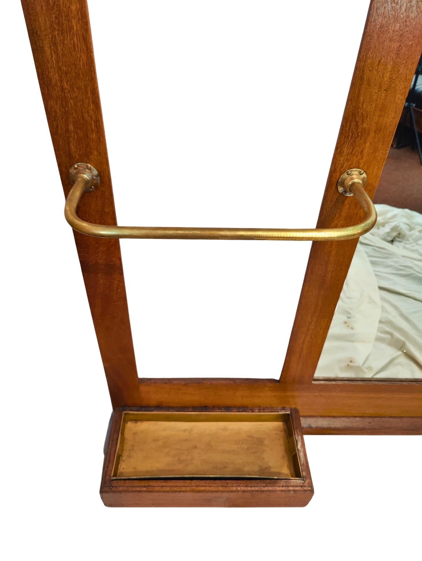 Very beautiful Art Nouveau coat rack made of oak wood with solid brass hooks. The coat rack has a large umbrella stand and four solid brass coat hooks. There is a shelf in the middle with an opening compartment underneath. The wardrobe dates from