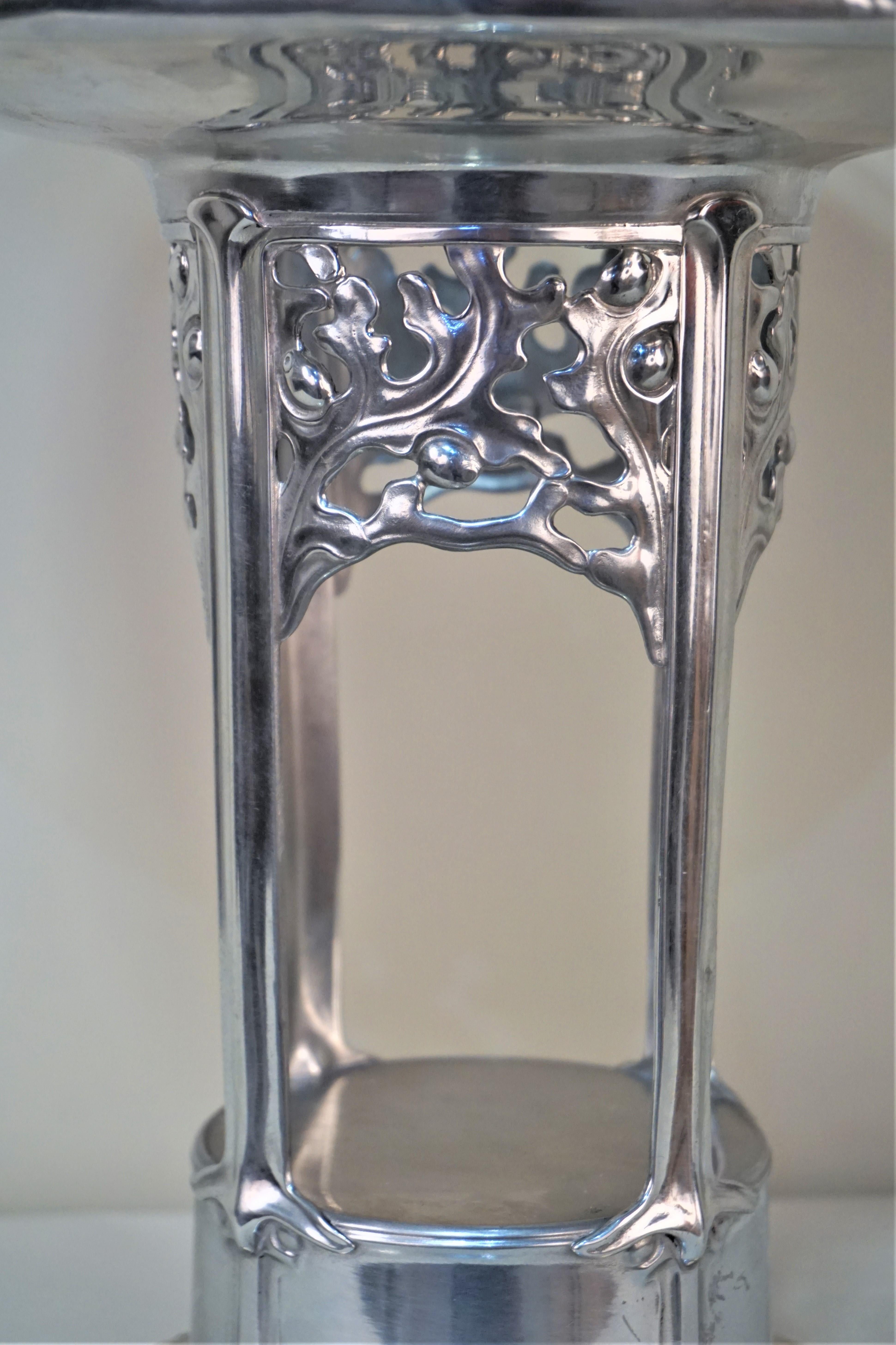 Sami polish pewter raised pattern art nouveau center piece with cut glass center liner.