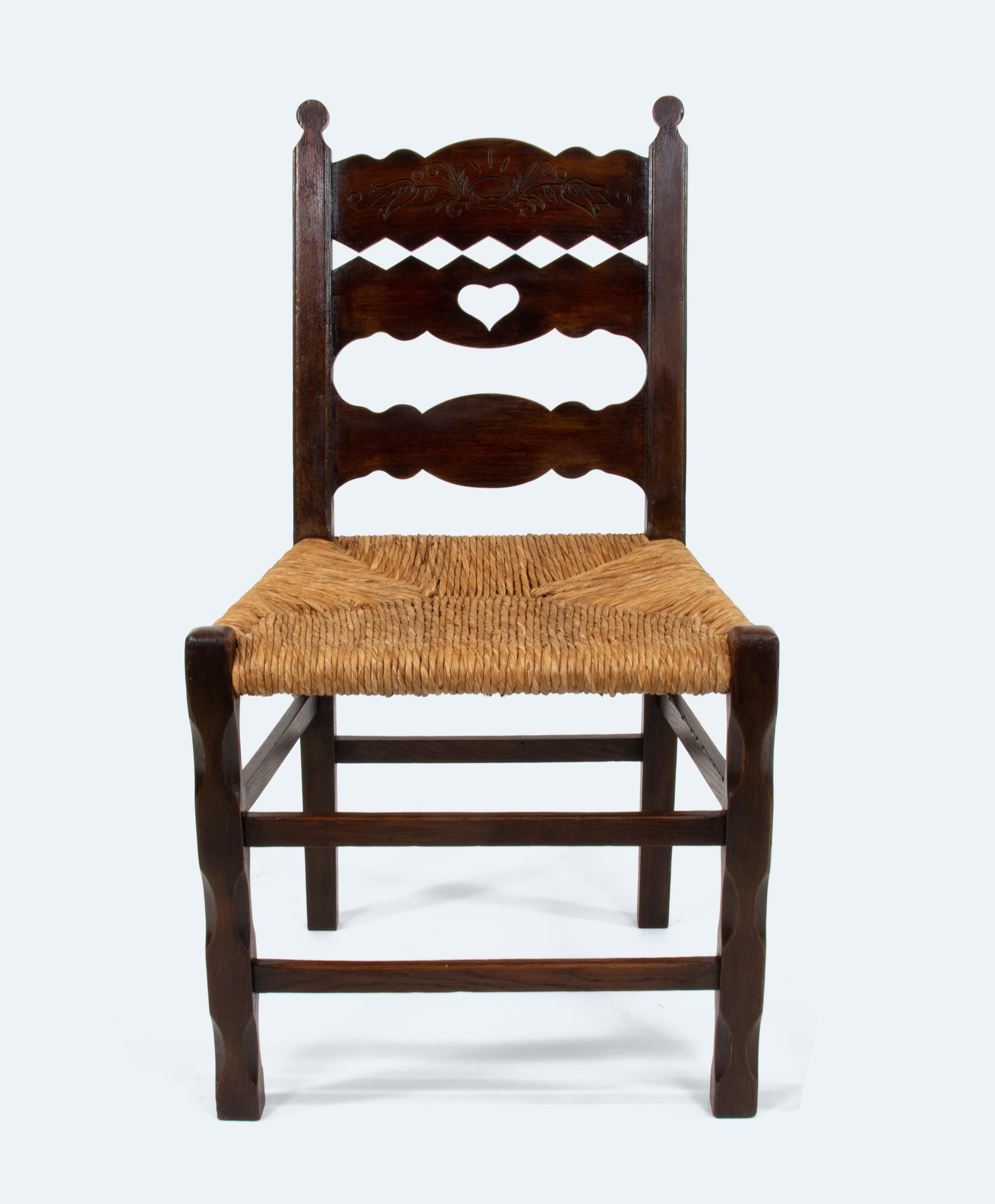 This elegantly crafted chair by Frido Witte reflects the essence of the Arts and Crafts movement, known for its focus on artisanal craftsmanship and natural materials. Made with a solid oak frame, dark lacquered for a refined finish, the chair’s