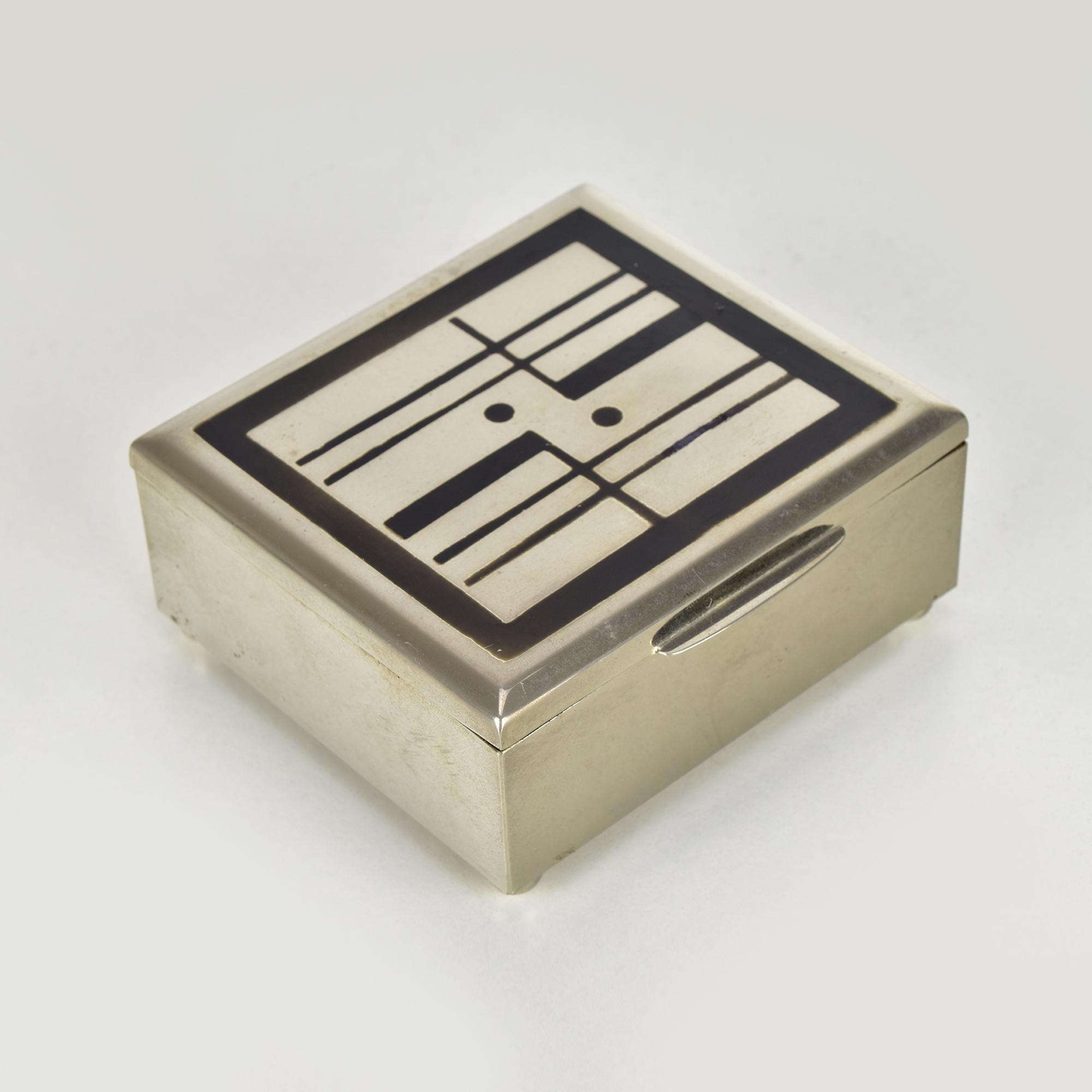 This exceptional German Bauhaus jewelry box, attributed to Marianne Brandt for Ruppel, embodies the constructivist design ethos with its geometric precision and minimalist aesthetic. The chromed exterior features an abstract, grid-like pattern on